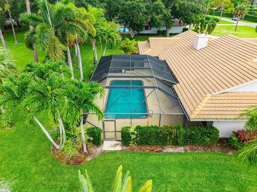 Experience refined Florida living in this meticulously maintained residence ideally positioned along the future 14th hole of the highly anticipated NOKOSI Golf Course, a private Jack Nicklaus-designed course scheduled for completion in the fourth quarter of 2026. Surrounded by lush landscaping, fruit trees, and swaying palms, this exceptional property offers both privacy and picturesque golf course views.From the moment you arrive, the home impresses with outstanding curb appeal, a grand circular driveway with additional parking, beautifully manicured landscape beds, and an elegant paver walkway leading to the double-door front entry. Inside, freshly painted interiors, terra cotta flooring throughout the main living areas, oversized sliding glass doors, and abundant natural light.  All creating an inviting and sophisticated atmosphere. The spacious living room is anchored by a charming wood-burning fireplace and seamlessly opens to the screened pool and patio area, perfect for effortless indoor-outdoor entertaining. The kitchen features stainless steel appliances, a breakfast nook with pool access, and convenient proximity to the formal dining room or optional office space. The private primary suite is a true retreat with new luxury vinyl flooring, fresh paint, two walk-in closets, a soaking tub, walk-in shower, and direct access to the pool and patio through sliding glass doors. Secondary bedrooms are thoughtfully split from the primary suite and share a well-appointed bath with a soaking tub, walk-in shower, and linen storage. Additional highlights include a 2020 roof, 2024 AC, hurricane protection for all windows, new attic insulation & ductwork, ceiling fans throughout, a spacious laundry room with soaking tub and cabinetry, and irrigation supplied by well water for the entire yard. The screened pool enclosure provides the ideal setting to enjoy Florida's year-round lifestyle in comfort and privacy. This exceptional home combines timeless character, thoughtful updates, and a premier golf course setting in one remarkable offering.