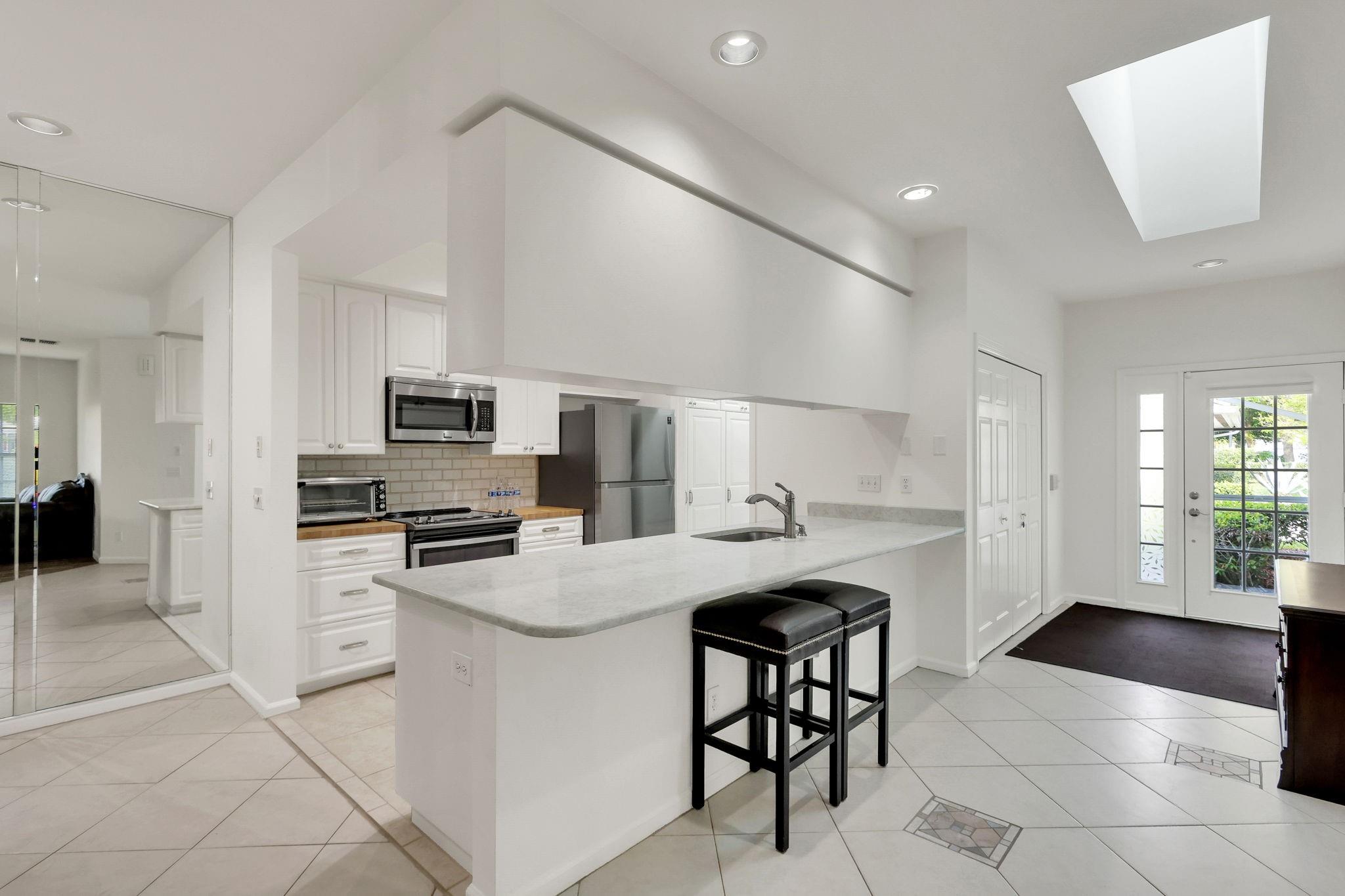 Enjoy Florida Living in this Fully Renovated 3Bed/2Bath Townhome in PGA Village! Open Concept is Perfect for Entertaining w/ a Fireplace in the Family Room. Dining Area Adorned w/ Wainscoting & a Bright, Inviting Kitchen Featuring Modern Cabinets & Hardware, Tile Backsplash, Butcher Block & Quartz Countertops, SS Appliances & Breakfast Bar. Master Suite Boasts Walk-in Closet w/ Custom Built-ins & Master Bath w/ Barn Door, Dual Vanities & Tiled-in Shower. Fall in Love w/ the Screened Porch & Teakwood Plank Ceiling! Other Features Include Vintage Style Tile in Guest Bath, Custom Built-ins in Laundry Room, Wood Grain Tile in Bedrooms, Mature Landscaping & Water Views. Desirable Community Amenities Include Cable, Internet, Building Insurance, Lawn Care, Security , Pool/Clubhouse & MORE!