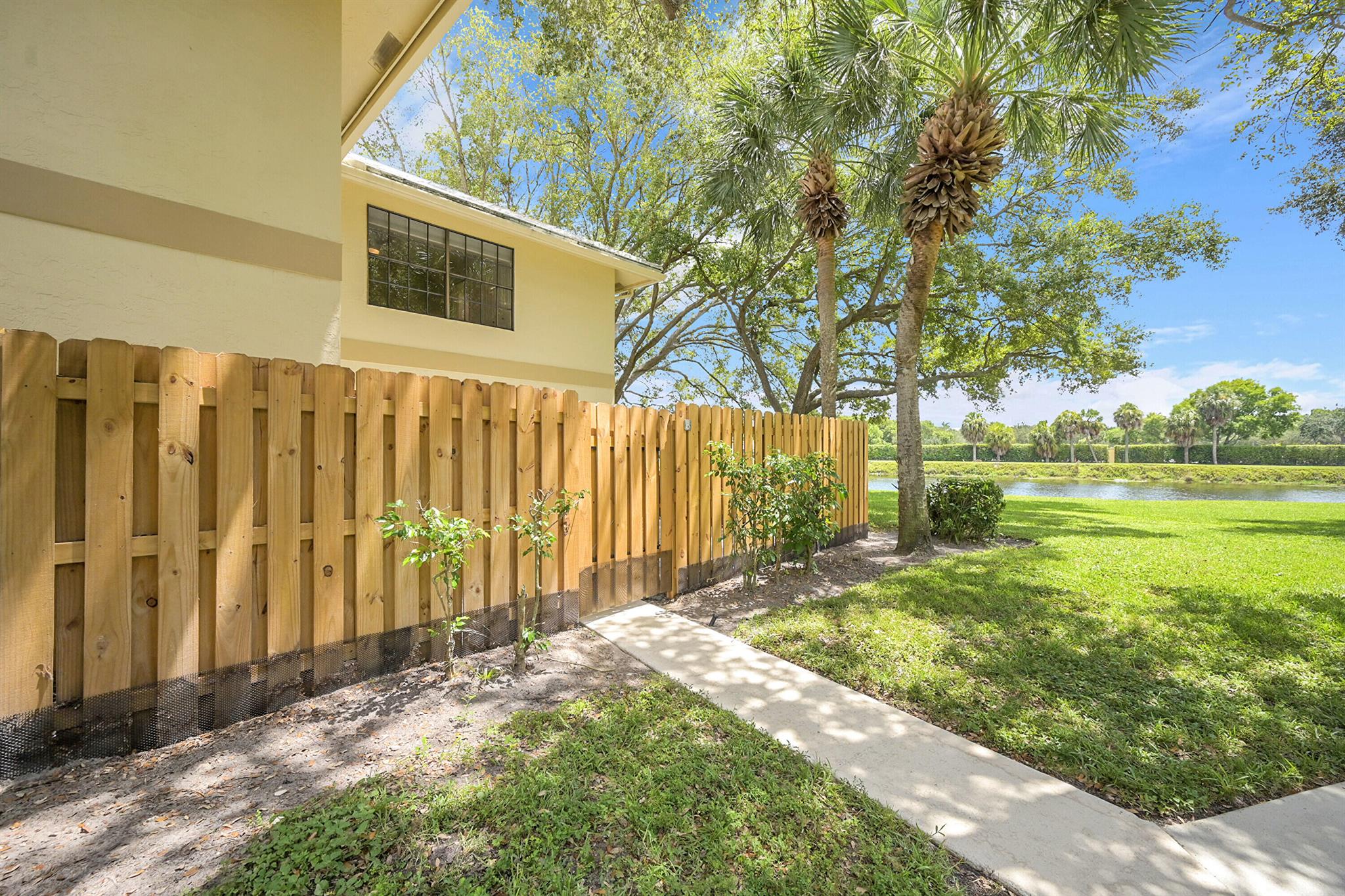Experience luxury in this stunning, COMPLETELY designer renovated corner unit townhome in Delray Beach. Situated along the serene C-15 canal, this 2-bed, 2-bath gem highlights floor-to-ceiling updates with high end finishes and custom craftsmanship. Tailored with tasteful renovations, Seller's pride shines in everything NEW - New expanded gourmet kitchen with stainless steel appliances - custom white cabinetry & quartz counter tops throughout + custom renovated bathrooms, lighting, flooring, paint, window treatments + multi-slide hurricane impact slider doors - the list is infinite! Private patio with custom open fence offers endless sunset vistas, canal breezes and more space for entertaining & alfresco dining with a view. Delray Oaks West is a pet friendly, all age community that hosts