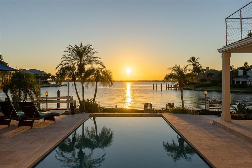 Newly Priced!! Elegant deep water estate home in desirable Anchor at the Moorings. Stunning views of the river from most every room. Wonderful outdoor spaces with riverfront pool to enjoy incredible sunsets over the intracoastal. Boater's paradise with 155' of riverfront, 26k lb boat lift & slip for up to 75' boat. New tile roof & ACs, whole house generator, impact glass, 2021 kitchen renovations with Quartz countertops & wine cooler, master bath renovations include Victoria & Albert tub and California Closets. New travertine pool deck and heater for saline pool. HOA with deeded beach access and manned security. This exquisite property is a must see!Sizes approx. Buyer must verify