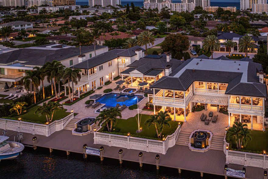 Rarely does an estate of this scale and distinction become available. Positioned on one of the largest Intracoastal lots in Boca Raton's prestigious Estate Section, this fully reimagined waterfront home offers 200 feet of frontage and showcases uncompromising quality, with exceptional materials and finishes selected throughout. Behind private gates, this expansive compound offers more than 12,000 square feet of refined interiors and over 17,000 total square feet across eight bedrooms, thoughtfully arranged between the main residence and a separate guest home. The layout is exceptional: the main residence features six beautifully appointed bedrooms, while the guest home includes two additional bedrooms, a full kitchen, a spacious living room, its own private entrance, and even an additiona 1-car garage dedicated to this suite a rare feature that enhances convenience, privacy, and long-term flexibility for guests, staff, or multigenerational living.

A dramatic double-height clubroom serves as the architectural centerpiece, seamlessly connecting the main residence to the guest home. With soaring volume, natural light, and gallery-like presence, this grand space allows the property to function as one cohesive estate or as two private living environments depending on preference.

At the heart of the home, a waterfront executive office captures serene Intracoastal views and includes a sophisticated adjacent lounge, creating a private, elevated environment ideal for work, meetings, relaxation, or quiet retreat. This wing stands out as one of the home's signature spacespairing functionality with an intimate, luxury atmosphere.

From the moment you enter the grounds, the scale of the transformation becomes clear. The exterior has been completely elevated with a full repaint, a brand-new roof including all flat sections, and enhancements to the sea wall. The entire property has been upgraded with pet-friendly turf, lush new landscaping, mature trees, vibrant flower beds, layered plantings, and a serene Zen garden accented by sculptural rock elements. Landscape lighting illuminates every contour of the grounds and trees, while updated sconces, downlighting, and outdoor ceiling fans create a warm, inviting ambiance from sunrise to sunset. Both the main and guest house gates now feature upgraded motors and modernized controls, complementing major mechanical upgrades that include a new whole-home generator with transfer switch, new exterior electrical panels, and a comprehensive outdoor security and sound system.

Designed for boating enthusiasts, the waterfront has been dramatically enhanced with a brand-new 200-foot dock and a 24,000-pound boat lift. The pool and spa area has also been elevated with new pool and spa tile, new coping, and upgraded equipment with full smart controls. Outdoor furniture features updated surfaces and all-new cushions, creating a polished, resort-style lounge environment ideal for entertaining or enjoying sunset views along the Intracoastal.

Inside, both the main residence and guest home have undergone a sweeping transformation. New wooden and tile flooring, freshly painted rooms and trim, modern lighting, and a curated interior palette give the home a crisp, sophisticated aesthetic. Significant mechanical improvements include the replacement of ten of the twelve A/C units and handlers, installation of new wireless routers, and a fully integrated Control4 smart home system managing lighting, audio, video, security, thermostats, gates, and garage doors. Every switch, outlet, and wall covering has been replaced, and all in-ceiling lighting has been transitioned to high-efficiency LEDs.

The main kitchen, redesigned by NEF Designs, showcases bespoke cabinetry, newly crafted counters, upgraded lighting, and premium Sub-Zero and Wolf appliancesincluding four additional refrigeration drawers.  Two newly built, temperature-controlled wine roomsone featuring a lounge seating areaadd architectural drama and serve as sophisticated spaces for entertaining or showcasing curated collections.

The bathrooms throughout the estate have been updated with new or modernized vanities and sleek plumbing fixtures, bringing a fresh, elevated feel to every room. The five-car garage servicing the main home has been enhanced with new cabinetry, improved surfaces, and new motors on all doors, further complemented by the additional 1-car garage at the guest home, bringing the total to six garages across the estate. Additional upgrades include new dining room windows and updated custom shade systems throughout, tying the interiors together with a polished, unified aesthetic.

With its comprehensive transformation, thoughtful layout, fully furnished interiors, state-of-the-art smart home technology, resort-style outdoor living, and premier Intracoastal presence, this estate stands as one of Boca Raton's most exceptional turnkey opportunities. Every detail has been curated to deliver an effortless, elevated lifestylemaking this waterfront compound a true modern masterpiece.