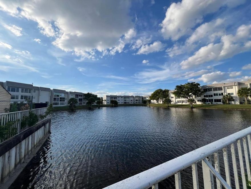 Enjoy serene waterfront living in this bright and spacious 2-bedroom, 2-bath corner unit condominium. Featuring tile floors throughout, new windows, and an enclosed patio, this home is filled with natural light from multiple exposures—perfect for relaxing or entertaining while enjoying tranquil water views.The layout offers comfortable living with plenty of potential. The property needs some minor work, making it an excellent opportunity to customize and make it your own. Located in an active 55+ community, residents enjoy a welcoming lifestyle with convenient access to public transportation, shopping, and nearby amenities.
