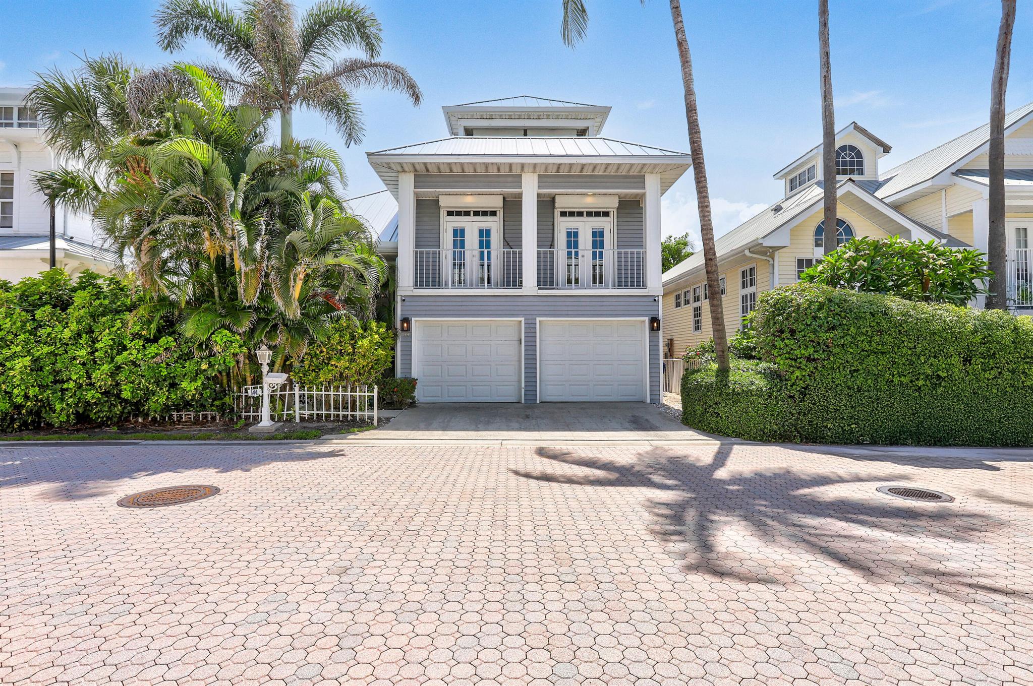Experience refined coastal living in this stunning Key West-style residence, ideally situated within the exclusive gated community of Jupiter Key. Just steps from the pristine Atlantic shoreline and directly across from one of the area's few dog-friendly beaches, this elegant property offers the perfect blend of resort-style amenities and everyday comfort--ideal for a full-time residence or luxury vacation retreat.Impeccably maintained and thoughtfully upgraded, this turnkey home features soaring volume ceilings, detailed crown molding, and recently installed hardwood flooring throughout the main living areas.