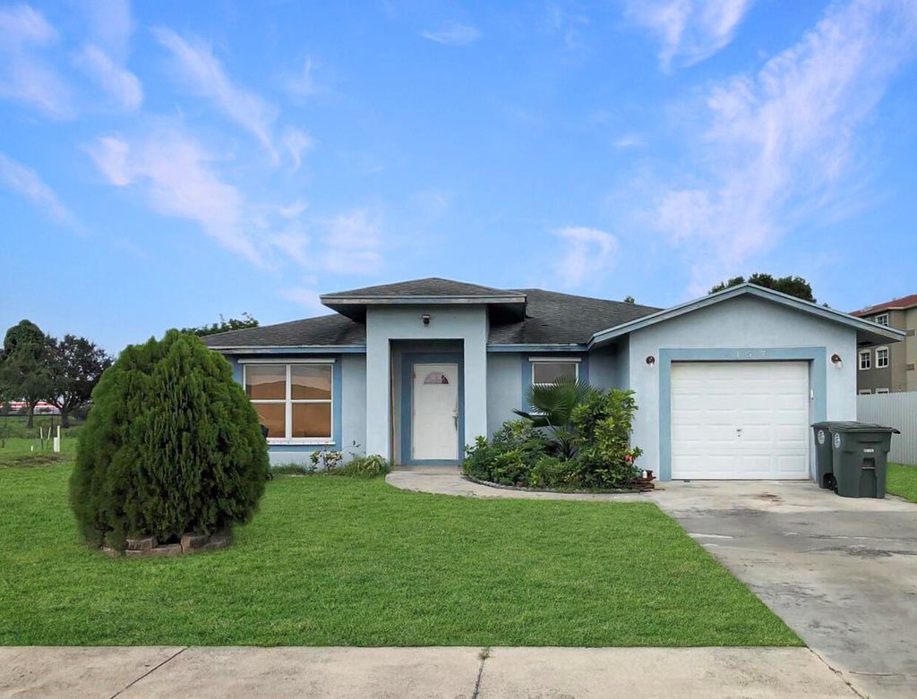 Photo of 157 Dabou Loop, Belle Glade, FL 33430 (MLS # R10912410)