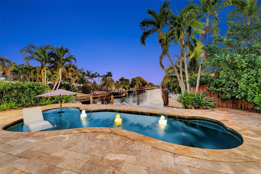 Renovated 3-bedroom, 2.5-bathroom on the Isles of Wilton Manors. Perfect for boating enthusiasts and an amazing view, ceramic tile flooring, recessed lighting, and impact-resistant windows and doors. With 45 feet of waterfront, enjoy a newer Trex dock and a lagoon-style heated and chilled saltwater pool complete with a water feature and built-in spa jets. The outdoor space is adorned with Travertine marble decking, a newer patio canopy, and lush tropical brand new landscaping. The kitchen is a chef's dream, featuring white cabinetry, new stainless steel appliances, a walk-in pantry, and a new quartz island and countertops. The modern bathrooms are completely updated. A versatile bonus room can serve as a media room, office, or studio, equipped with A/C and a half bath! Newer roof and AC!