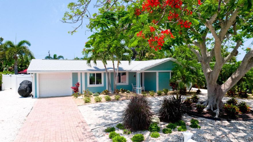 This newly and fully remodeled open floor plan 3-bedroom, 2-bathroom Holmes Beach, FL home is now offered WITH DEEDED BOAT SLIP AND BOAT LIFT as a move-in ready dream come true. Here you will enjoy the ''old Florida'' feel of the quiet neighborhood along with the benefit of the totally private back yard and a gorgeous marina water view across from the front of the home. The DEEDED boat slip is only 50 yards from front of the home in the canal marina directly across the street and has a updated dock, 13,000 lb lift, water, electric, and can support a boat with up to 9.5 ft beam and 30 ft length overall. This home has hurricane-rated windows (2023) with Levolor Custom Sheer Shade window coverings, new ceramic tile flooring, a beautifully revamped kitchen with new GE stainless steel appliance (2025), new GE large capacity front load washer/dryer (2025), and newly tiled spa-like bathrooms. Comfort is assured at all times with a brand-new Carrier A/C with heat pump and smarthome thermostat (12/2025) and a tankless water heater (2023) for never-ending hot showers. The backyard is a private tropical oasis featuring a heated saltwater pool with a new pool pump (11/2024), pool heater (12/2025), a top of the line 2022 HotSprings Vanguard saltwater hot tub with all new (2025) heaters, pumps and controllers, lush irrigated landscaping, a 6ft privacy fence, and a massive fan cooled and lighted tiki-covered paver patio for entertaining. The home exterior has updated HardiePlank siding, fresh paint and gutters, a 2019 roof, and beautifully landscaped yard along with the marina canal views right across the street. Just steps from the Gulf beach and close to everything that makes Anna Maria Island greattop restaurants, bars, boutiques, and all the beach and cart-riding fun you can handle to provide the ultimate island living experience. Finally, and very importantly, this home has no HOA, no Master Association, no CDD, and can be (is currently) Homesteaded.