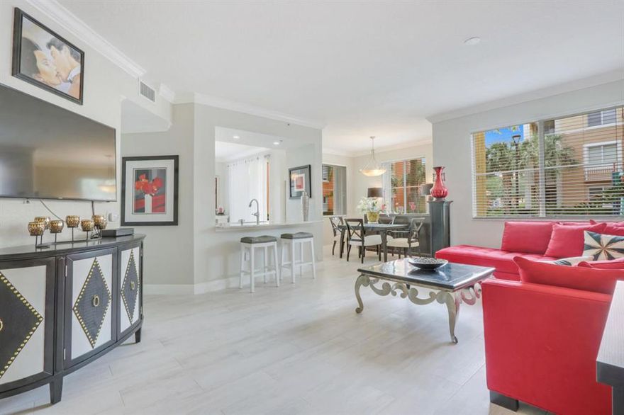 Beautifully & Completely Renovated First Floor, 2-bedroom, 2 bath Condo w/ Walkout Patio. This Spacious Corner Unit has Lots of Natural Light & Garden Views.  Newer Tile flooring throughout, Crown & Base Molding Throughout, 2nd Bath Completely Remodeled, Kitchen features designer cabinets enhanced with soft close doors, custom lighting, granite counters, and modern stainless appliances. For added convenience, there's access to an extra storage room. Full Accordion Hurricane shutter Protection Throughout & Tankless Water Heater. Legacy Place is gated community with resort style amenities, like: Pool, Tennis Courts, Fitness Center + More! Walking Distance to Great Shopping & Restaurants.