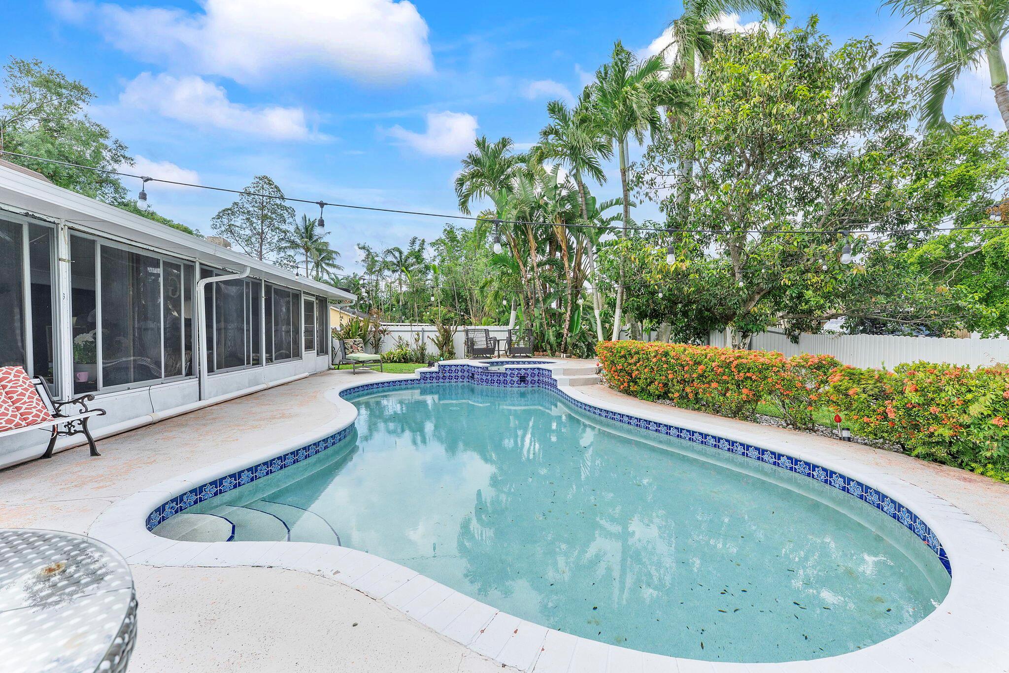 WATERFRONT - POOL - CORNER LOT - IN-LAW SUITE - LAKE DECK- NO HOA This UNIQUE PROPERTY has it all and offers the perfect blend of comfort, versatility, and location, ideal as an AIRBNB INVESTMENT or a FAMILY DREAM HOME. Located in the heart of DESIRED PEMBROKE PINES, in a QUIET, FAMILY-FRIENDLY NEIGHBORHOOD, just minutes from main avenues, the FLORIDA TURNPIKE, top-rated SCHOOLS, STORES, RESTAURANTS, and more. This 4 BEDROOM / 3 BATHROOM home sits on a spacious CORNER LOT with MATURE LANDSCAPING and features an OPEN FLOOR PLAN, TILE FLOORING THROUGHOUT, a MODERN KITCHEN WITH STAINLESS STEEL APPLIANCES, and UPDATED BATHROOMS. Enjoy LAKE VIEWS FROM YOUR ENCLOSED PATIO, unwind on your PRIVATE LAKE DECK, and host guests by the SPARKLING POOL and CUSTOM OUTDOOR BBQ COUNTER.