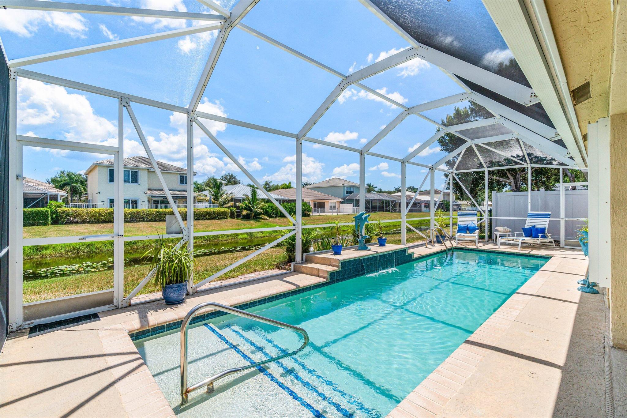 Welcome to a beautifully maintained single-story pool home located in the desirable gated community of Lantern Key. This 3-bedroom, 2-bath residence offers the perfect blend of comfort and convenience, with serene water views. Step inside to an inviting open floor plan where the kitchen flows seamlessly into the great room--perfect for both everyday living and entertaining. The kitchen features ample counter space with a kitchen island. Enjoy year-round relaxation in your private screened pool with tranquil waterfront views right from your backyard. Accordion shutters provide peace of mind, while the 2022 AC ensures efficiency and comfort. Additionally, there is a spacious primary suite, and a two-car attached garage. Lantern Key offers a clubhouse, fitness center, pool, and playground.