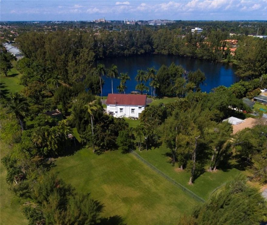 Wow! 12 Acres with an "In town" location and opportunities abound. A very unique property with a picturesque, tranquil lake reminding one of South Floridas unspoiled past!  Currently, an older 4,000 SF home graces the property, but this is all about the land!  Current Land Use allows for up to 60 units with 6.19 Acres of usable upland and 5.86 acres of submerged lake land area. Build the estate of your dreams tucked away from the hustle and bustle of it all, but only minutes to I95, the airport and downtown Fort Lauderdale.  The Existing zoning allows for a "Green Acres" vibe as well, with Agricultural uses permitted with some exceptions.