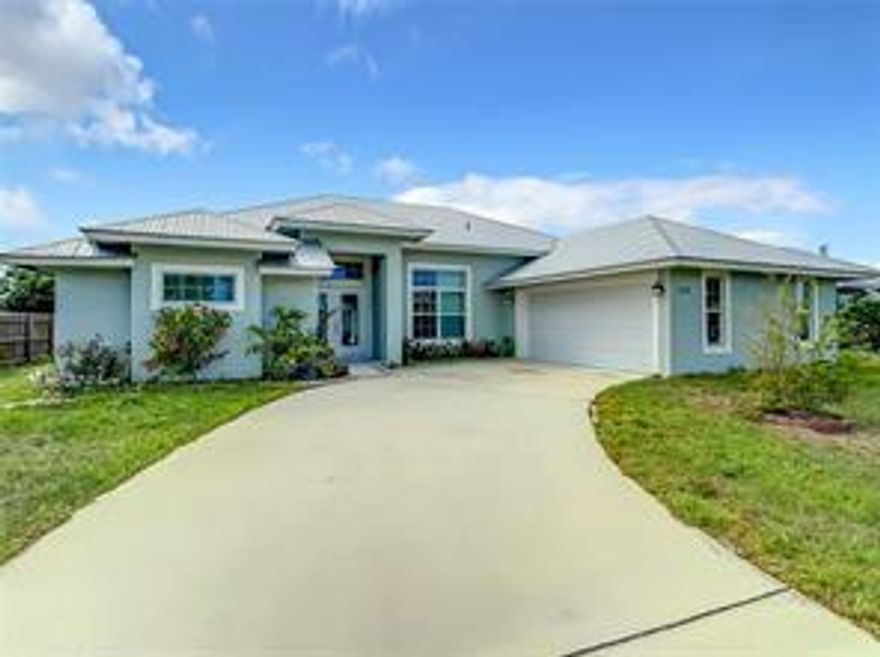 This PRISTINE and spacious Port St. Lucie home offers 4 bedrooms and 3 full baths located across the street from the 6.5 acre Swan Park playground and soccer fields! READY FOR IMMEDIATE MOVE-IN! The double front doors invites you into this OPEN floorplan that offers a grand living area and 2 of the bedrooms with their own PRIVATE bathrooms. There is a guest bath which has access to the backyard, LARGE enough to build a future pool! Meticulously MAINTAINED, built in 2019 and a metal roof that offers decades of use. Interior features include recessed lighting, high ceilings, porcelain tile (NO CARPET). The kitchen is a chef's DREAM with stainless steel appliances, granite countertops and a wrap around breakfast bar. TAKE THE 3D VIRTUAL TOUR!  NO HOA!!