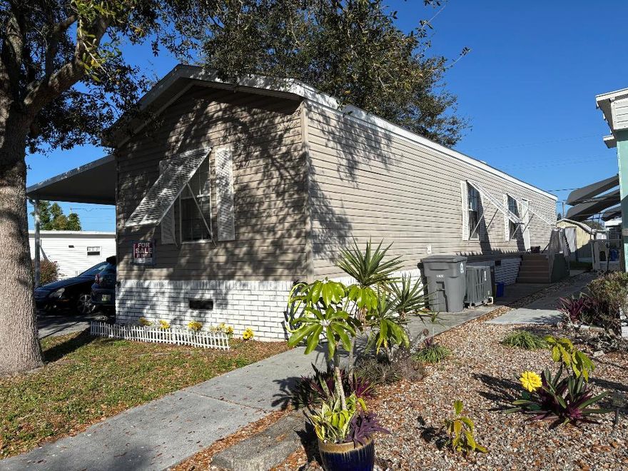 Single wide, 2-bedroom, 2 bath set on single deeded lot - you own the land! One of the newest builds in community - Built in 2005! Low Hoa of only 1224/year which includes water and lawn care. Property features a large driveway that can accommodate 4 cars, a new water heater, laminate flooring and split bedroom floorplan. No carpet here!  Almost totally fenced in spacious yard with no home to the left/north of your home. Pine Grove Village is a pet friendly manufactured home community for 55 years of age and older. There is a clubhouse on property, shuffleboard and BBQ grills.