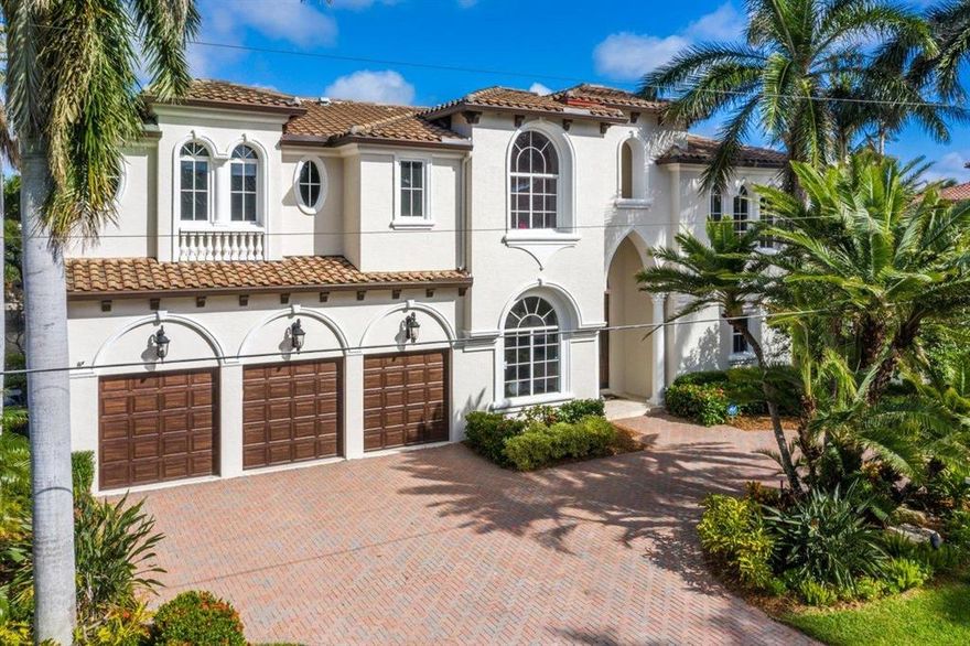 Come Home To Your Castle On The Canal In Tropic Isle Where You Can Bring Your Large Yacht & Large Family! Love to Entertain? This is an Impressive Home Boasting 90 Ft. of Waterfront, 5 Bedrooms, 5 1/2 Baths w/ Plenty of Room to Roam in this Outstanding Open Floor Plan*Large Impact Glass Windows & Doors Welcome Natural Light & Magnificent Water Views*The Lower Level has Volume Ceilings, Architectural Details, Custom Millwork, & Marble Floors*Spacious Rooms Include a Formal Dining Room, Grand Living Room, Chefs Kitchen w/ Snack Bar Counter, Family Room, Custom Built-In Office/Den, Private Guest Bedroom w/ Full Bath, & Powder Room*The Elevator & Wide Staircase Leads to the 2nd Level w/ Rich Wood Floors Throughout*A Substantial Club Room Beckons You Outdoors to a Newly Remodeled Sundeck...