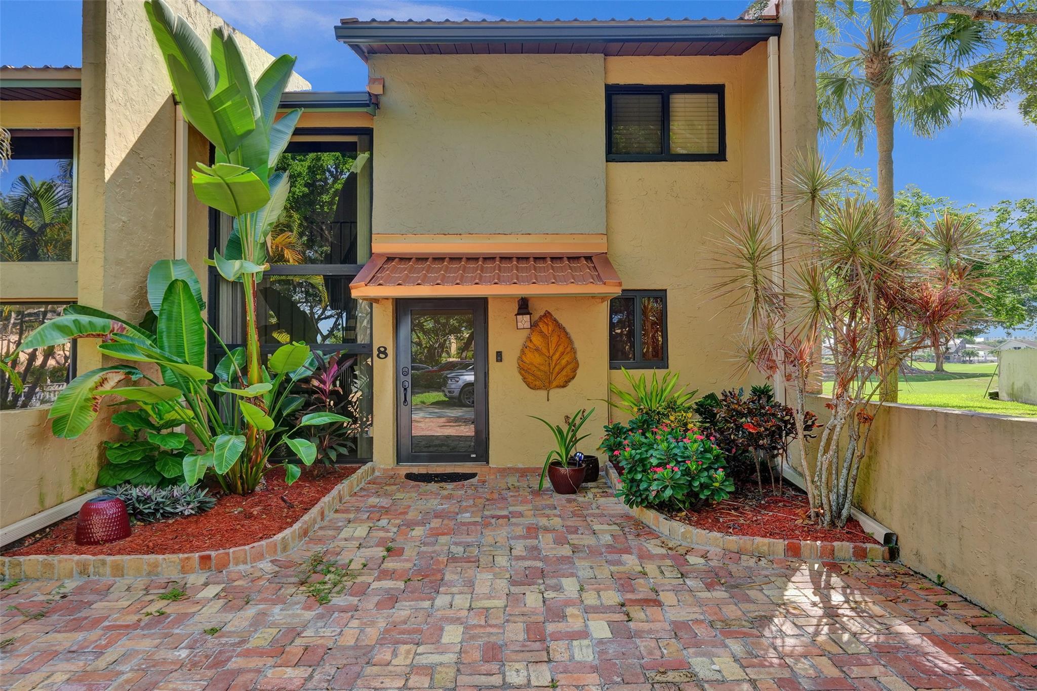 Beautifully renovated corner-unit 2-bed, 2.5-bath townhome in tranquil & sought-after Jacaranda Country Club. This meticulously maintained home features impact doors & windows on 1st floor. Upgraded kitchen boasts modern white shaker cab., quartz counters, newer stainless appliances & updated lighting. Oversized primary suite offers extra space, perfect for a home office, while all bathrooms have been tastefully updated w/ contemporary finishes. Enjoy abundant storage w/ lg. closets. Newer roof & 2018 A/C. Step outside to your private patio overlooking scenic Jacaranda Golf Course, surrounded by lush green space—ideal for relaxing & entertaining. In unit W/D and freshly sealed Chicago brick paver driveway. Conveniently located near shopping, dining, highways & Ft. Lauderdale Int'l Airport.