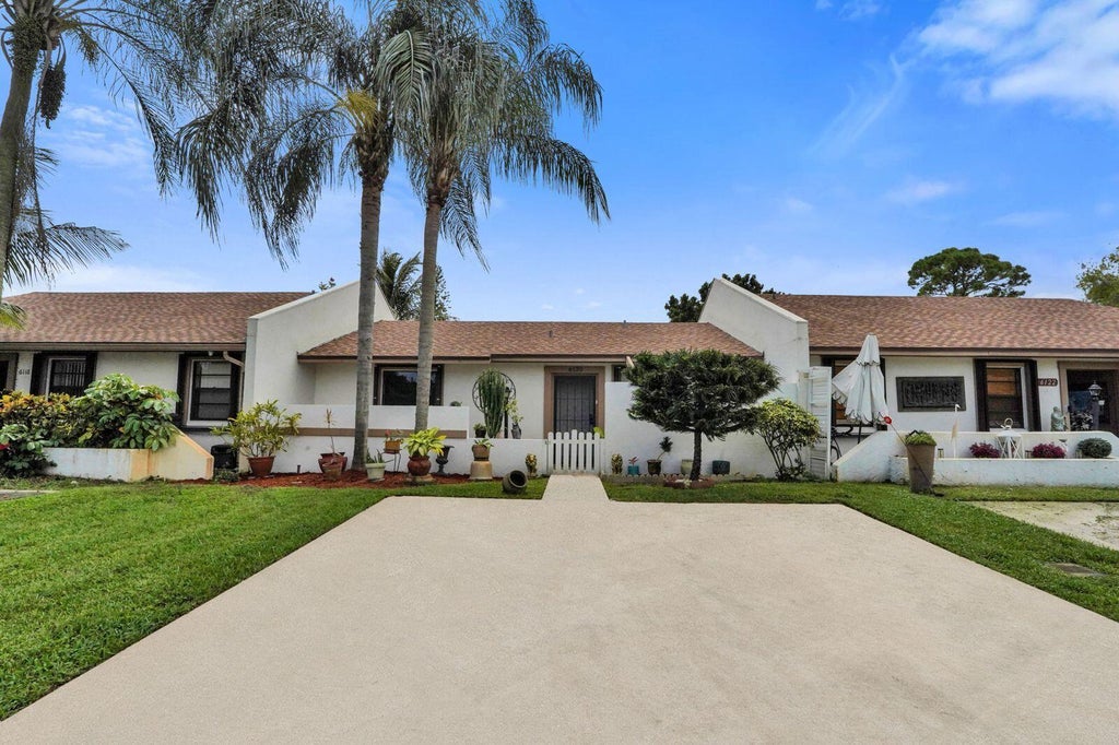 Photo of 6120 FAIRFIELD Circle, Greenacres, FL 33463 (MLS # B26091974)