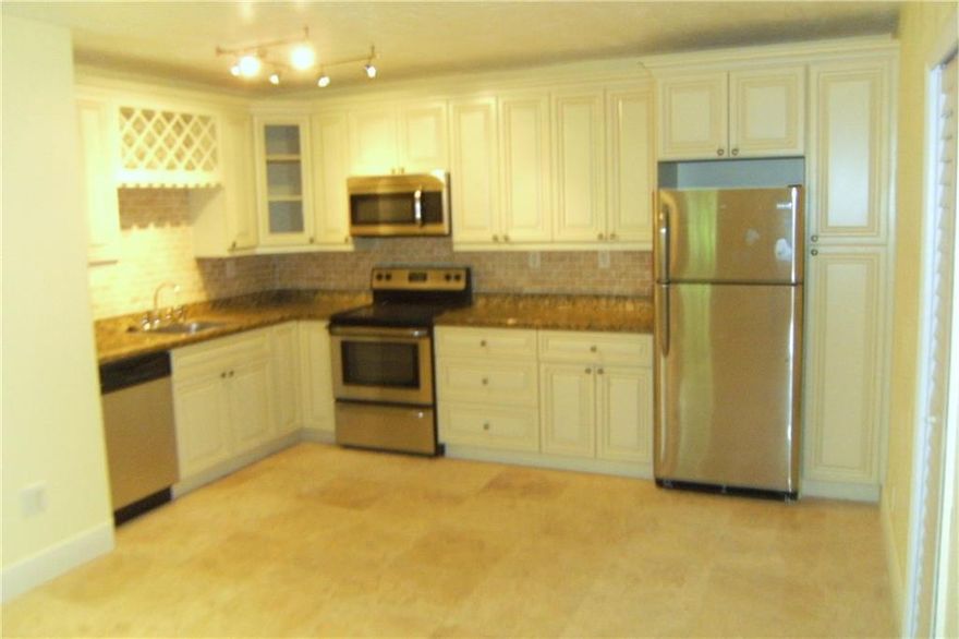 Available August 1.  This apartment is remodeled with excellent upgrades!  Travertine marble floors thru-out, impact windows, new kitchen with granite counters, custom cabinets, Frigidaire stainless microwave, dishwasher, refrigerator and smooth top range.  Spacious and open living and kitchen area.  Private washer & dryer inside the apartment!  Corner unit on the 1st floor with fenced patio.  Located seconds away from Wilton Drive in a residential neighborhood!  Small pets welcome with $250 pet deposit.