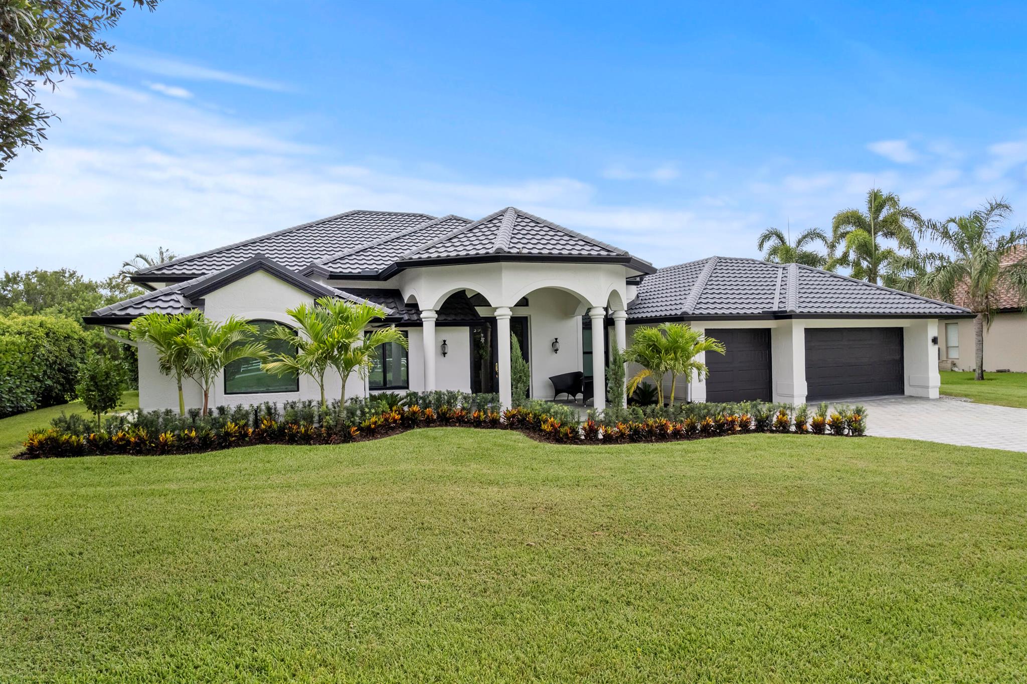 Welcome to 1340 SW Squire Johns lane, a beautifully remodeled 4 bedroom, 3- Bath single family home located in one of Palm City's most desirable neighborhoods. Set on a spacious half acre lot, this 3876 sf ( under air 2704 sf) residence offers the perfect combination of timeless architecture, modern luxury, and Florida lifestyle. This open concept home features a gourmet kitchen with oversized quartz island, high-end finishes, & LVF. Soaring ceilings with coffered/tray details, new electric & plumbing in the home, & custom baths. Major upgrades include new metal tile roof, impact windows & sliders, hurricane rated garage doors, new well and water system, spray in insulation, and more. Enjoy a private backyard oasis with an in ground pool/spa with fencing and lush privacy. A must see!