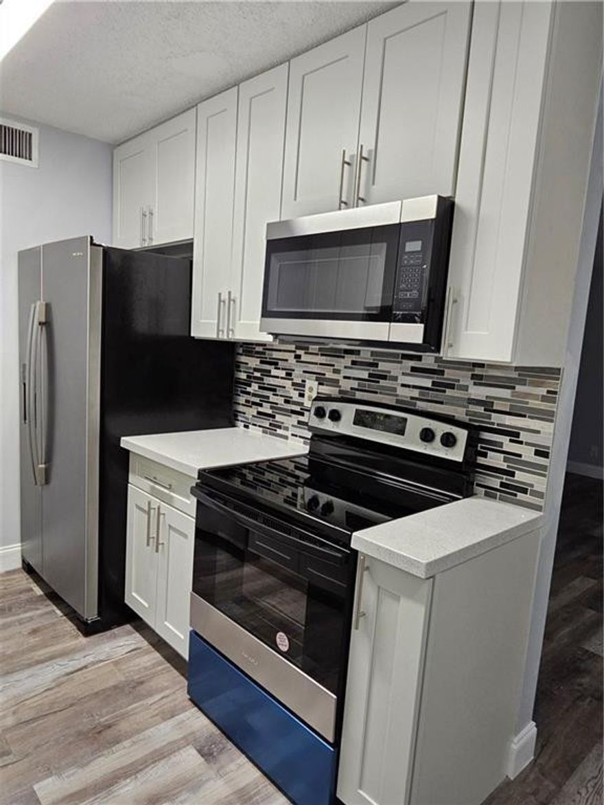 Fully renovated 2-bedroom, 2-bathroom garden apartment offers a beautiful lake view. The upgrades include a new kitchen with granite countertops and stainless steel appliances, and newer bathrooms with parquet flooring. Freshly painted, in addition, the unit is equipped with a washer and dryer. The complex has a community pool and is conveniently located near Shopping, restaurants, malls, and Main Road.