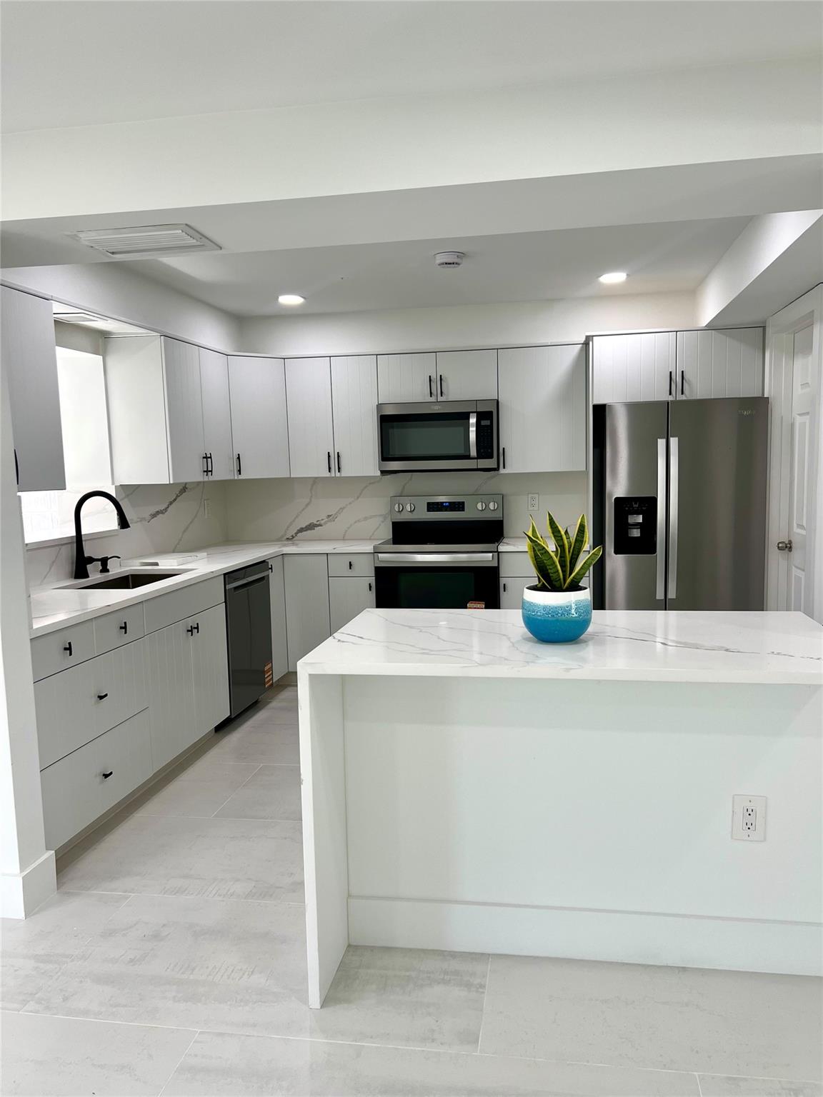 EAST BOCA.....1 Mile to the BEACH....Stunning just recently renovated east Boca home. 3 bed 2 bath with large Yard, 1 car garage & circular driveway. Light & bright with large tile floors, quartz counters, updated bathrooms, impact windows, stainless steel new appliances. Quite neighborhood. A must see