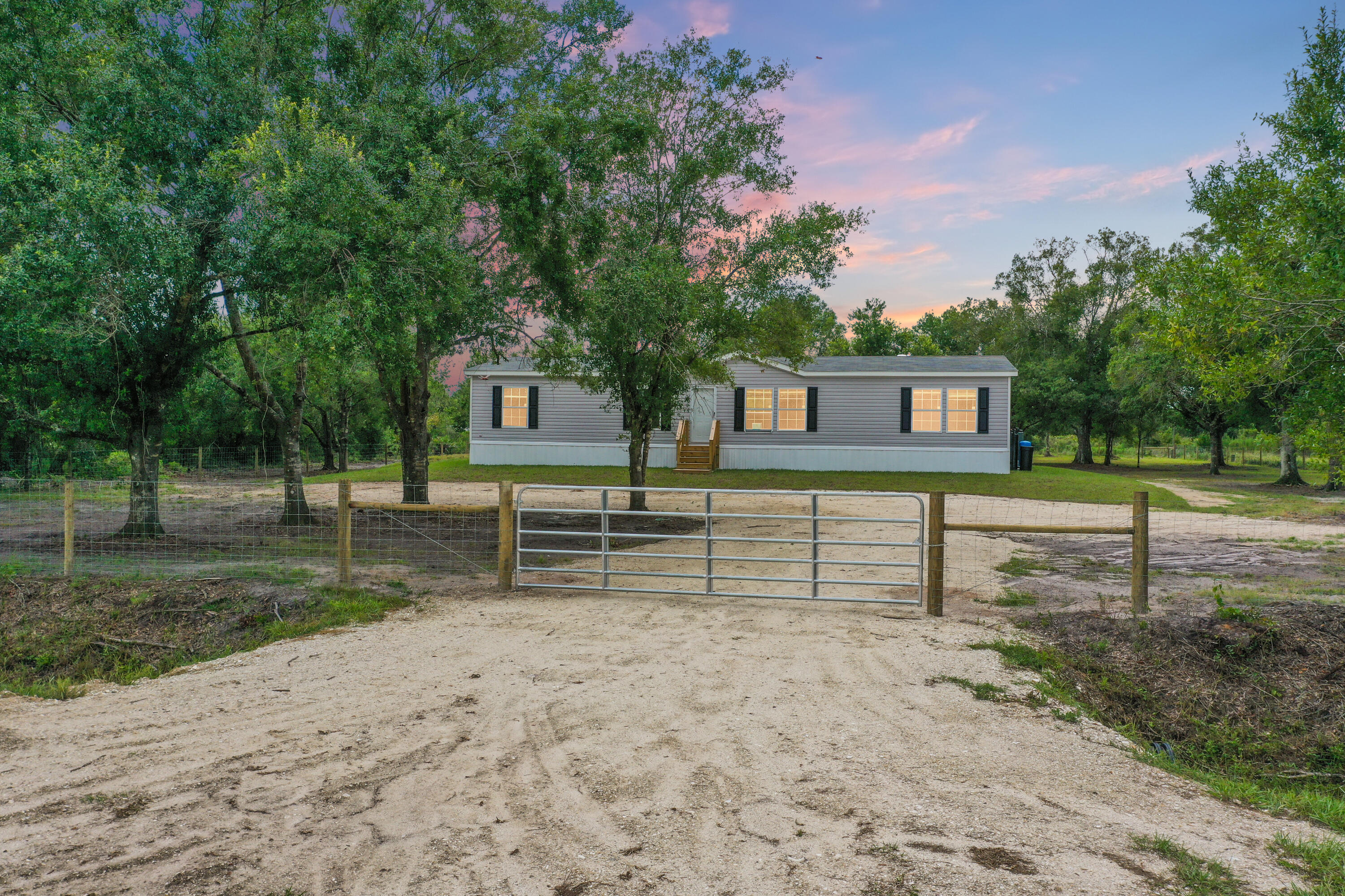 Brand new 2025 4-bedroom, 2-bathroom home on 1.25 beautiful, high-and-dry acres in peaceful Okeechobee! This move-in ready property offers 1,680 sq ft of living space surrounded by mature oak trees and fully enclosed with fencing and a private entry gate for added security and seclusion.Built with all impact glass windows and a Wind Zone 3 rating, this home is designed for durability and peace of mind. Inside, you'll find an open, functional floor plan, modern finishes, and a complete kitchen with all appliances included. The home also features a whole-home water softener system and is FHA/VA financing approved.Enjoy the freedom of country living--no HOA, plenty of room for your RVs, boats, or animals, and the tranquility of your own slice of nature. Turnkey and ready.