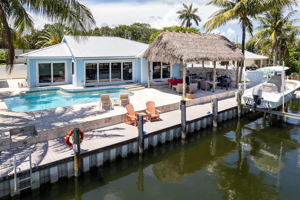 Magnificent CBS 3BD/2BA home built in 2014 with the finest details and finishes.103'of waterfrontage on a deep wide water direct intracoastal canal with turning basin and no fixed bridges.98' Trex dock with 12k lb lift and new seawall.Metal roof,PGT impact windows and doors12'vaulted ceilings,porcelain'white glass'tile,engineered handscraped hardwood floors,surround sound inside and out,Hunter Douglas window treatments,tankless water heater,security system with Ring doorbell,LED lights throughout.Gourmet kitchen offers custom cabinets,and Wolf/Sub Zero/Bosh appliances -gas cooktop,wine cooler,farmhouse sink,elegant quartz countertops,chef island with vegetable sink,breakfast nook.Custom wood built in entertainment center with real electric fireplace that accommodates an 85''TV.