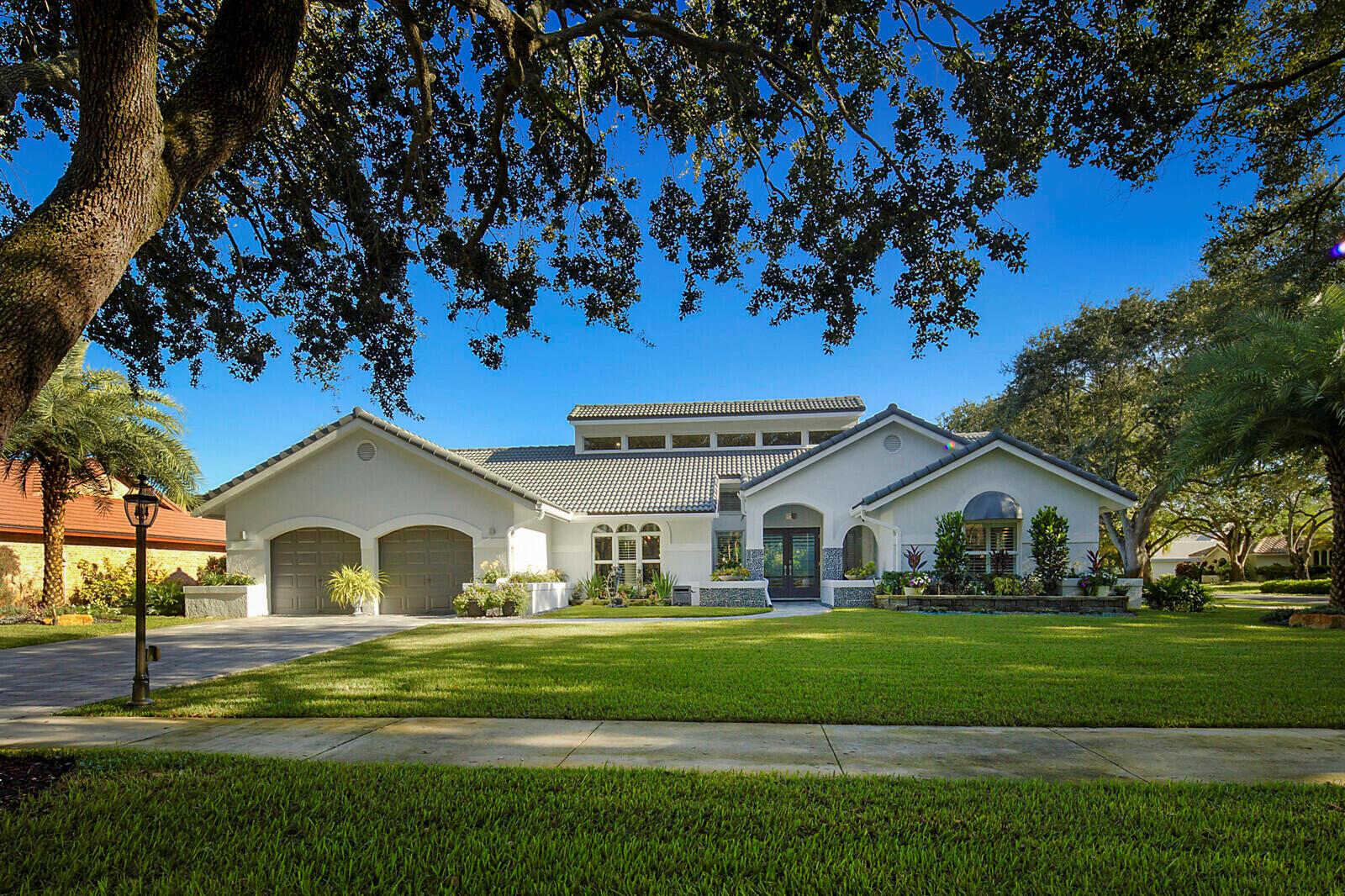 This Exquisite Estate in Delray Beach's Prestigious Rabbit Hollowe is a true tropical sanctuary in the heart of Delray Beach. Tucked away in the boutique luxury community of Rabbit Hollowe, this beautiful 4-bedroom, 3-bath estate sits on a meticulously landscaped third of an acre corner lot, offering both privacy and prestige. From the moment you step through the grand entrance, you'll be greeted by soaring 14-foot ceilings, streams of natural light, and an open-concept floor plan that flows seamlessly from one elegant space to the next. The heart of the home is the stunning chef's kitchen, designed with both beauty and function in mind. Outfitted with induction cooking, premium appliances, and custom cabinetry, it's the perfect stage for preparing everything from casual family meals to