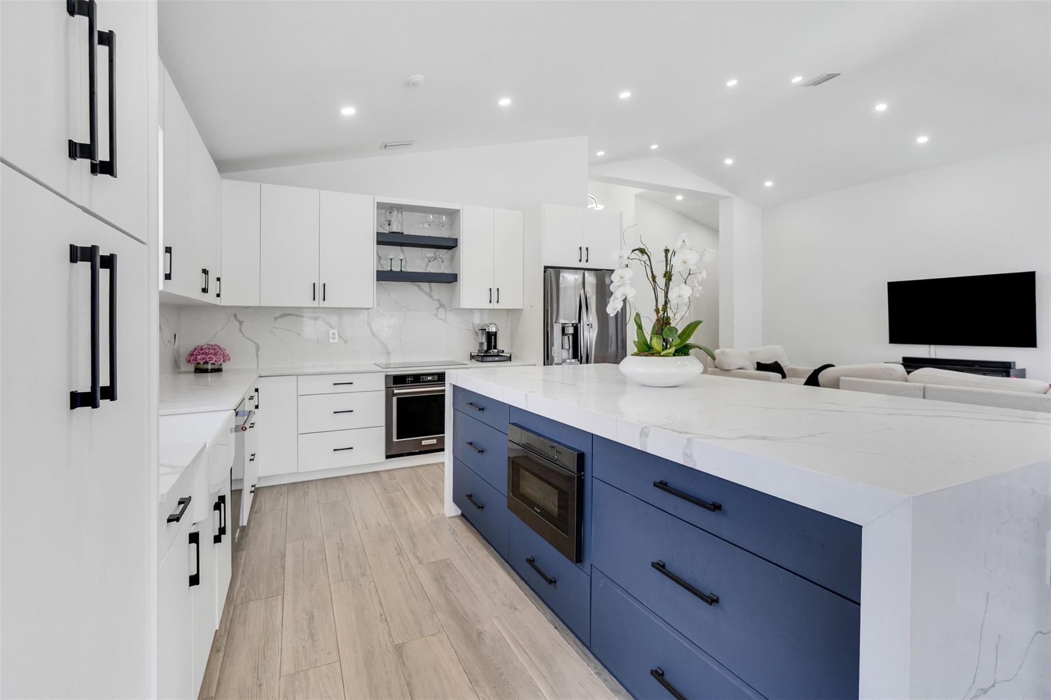 Nestled on a quiet cul-de-sac in the gated community of The Falls, this Weston home combines modern updates with a prime location. Sitting on the largest lot in the neighborhood (¼ acre), it features an open layout with 3 bedrooms, 2.5 baths, a 2-car garage, and a 30' x 10' pool. Renovations include a new 2022 roof and A/C, stylish new flooring, high ceilings with LED recessed lighting, a sleek kitchen with quartz countertops and black stainless appliances, a matching built-in bar, updated bathrooms, and custom closets. The PVC-fenced backyard offers privacy and plenty of space to relax or entertain. Zoned for A-rated schools and minutes from major highways, shopping, and dining, plus low HOA fees, this move-in ready home has it all