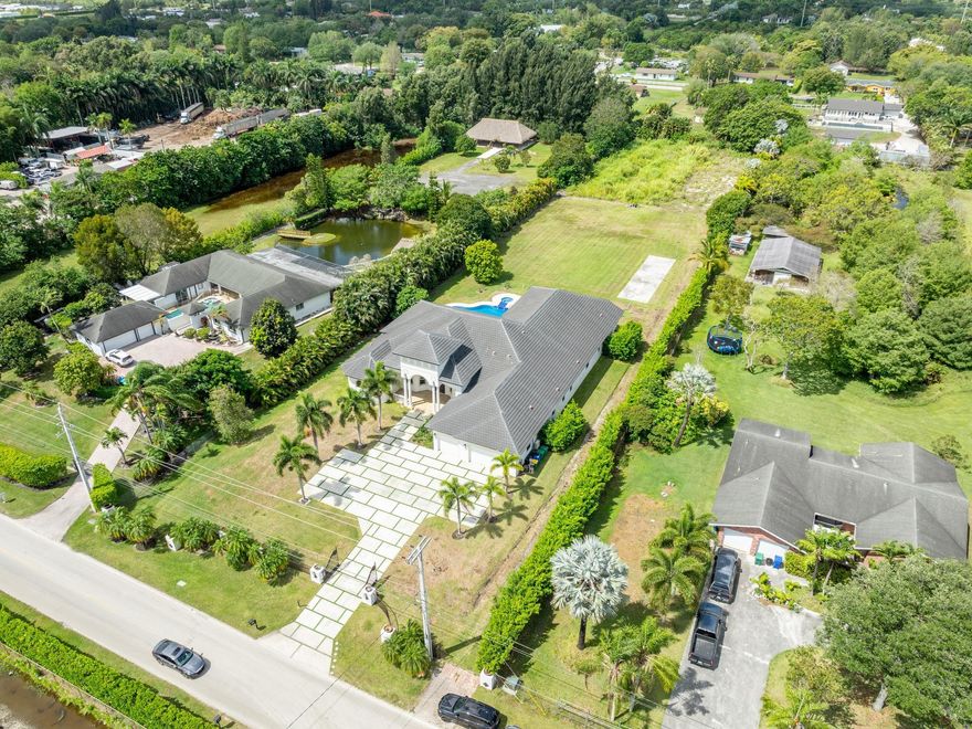 ***LUXURY CUSTOM-BUILT ESTATE*** NESTLED ON OVER 2 ACRES IN THE PRESTIGOUS TOWN OF SOUTHWEST RANCHES. DESIGNED FOR BOTH COMFORT AND ELEGANCE, THIS HOME FEATURES A NEWER ROOF AS WELL AS A THOUGHTFULLY DESIGNED TRIPLE SPLIT FLOOR PLAN, OFFERING PRIVACY AND SEAMLESS FLOW. ENTERTAIN WITH THE OPEN-CONCEPT KITCHEN WHICH SEAMLESSLY CONNECTS TO THE FAMILY ROOM AND BAR AREAS. EXQUSITE MARBLE & WOOD FLOORING THROUGHOUT. RELAX IN THE THEATRE, STEAM SHOWER OR RESORT STYLE POOL/SPA WITH TRAVERTINE DECKING. THIS HOME EMBODIES TIMELESS SOPHISTICATION ALL THE WHILE ENHANCED BY TRANSITIONAL ARCHITECTURE.