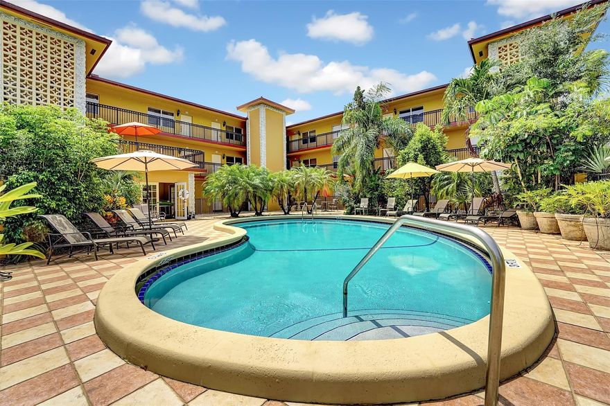 YOUR OWN PRIVATE PATIO. W/D in unit. 2 bed/2 bath 1st Floor Corner Unit W private patio in Boutique Building Situated in Desirable Victoria Park! Walk right out your door to the pool. Meticulously maintained unit features newer tile floors throughout, BRAND NEW 2024 fixtures, crown molding, built-in closet systems and updated kitchen with granite counters & SS appliances. Beautiful French doors lead out from living area to private spacious patio, great for entertaining and barbecuing! 2 ASSIGNED PARKING SPACES  AND Washer/Dryer IN UNIT. appliances new within last 2 years. Gated PET friendly building with private tropical pool area across the street from Holiday Park. Restaurants! Can Rent right Away!!! FAST APPROVAL