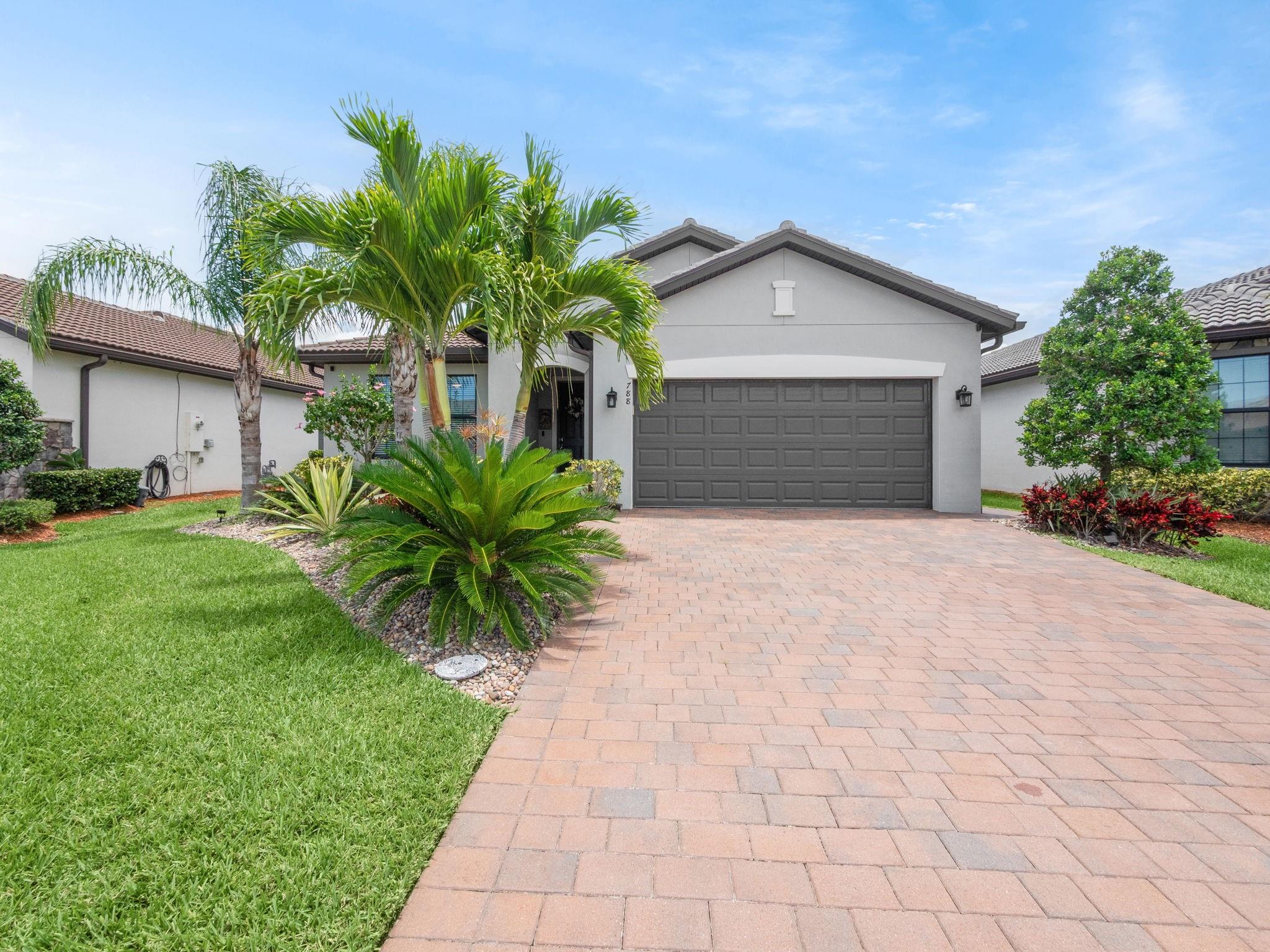 SELLERS HIGHLY MOTIVATED! Welcome to 788 SE Villandry Way, where luxury meets convenience! Built in 2020 and barely lived in, this 4bed/3bath, 1,972 SqFt of living space and a total of 2,410 sq ft home offers perks of new construction without builder delays or punch lists. Amenities galore in gated Veranda Gardens! Enjoy seller investment in premium upgrades: huge Jacuzzi, gourmet kitchen cabinets, quartz countertops, elegant lighting, oversized patio with pavers, screened lanai, epoxy garage floor, impact glass and more! Golf cart to Publix, restaurants, shopping under a mile away. Located in sold-out Veranda Gardens with low HOA fees and lawn service included, this turnkey home won't last! CALL NOW TO SECURE YOUR SHOWING!