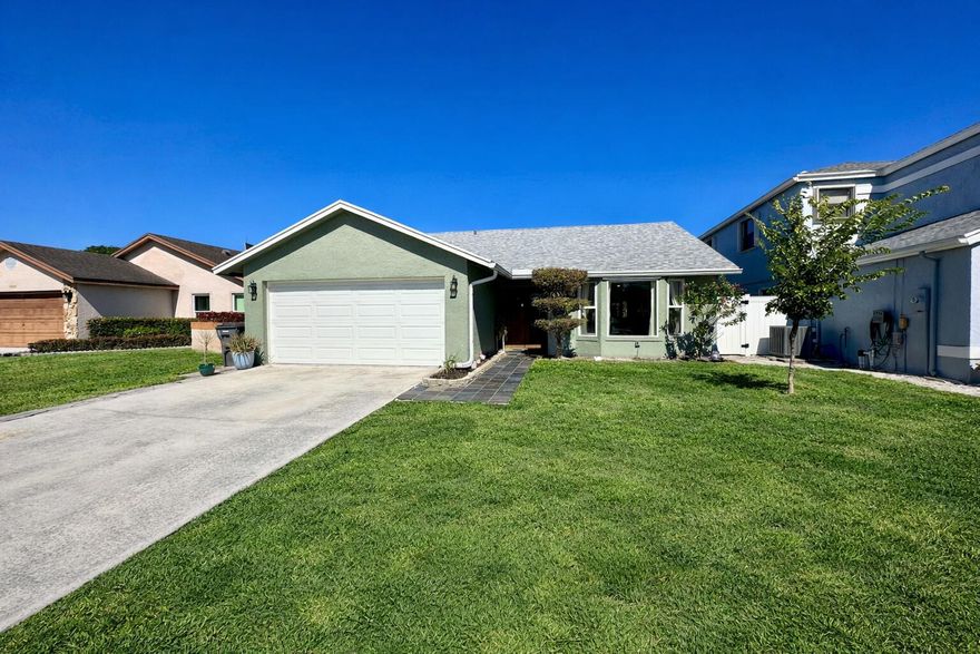 3/2 Single Family House with fully fenced yard, 2-car garage and large driveway. Open concept home with tall ceilings in the main living area. Great location in West Palm Beach with nearby shopping, restaurants, and entertainment. Kitchen has taupe cabinets, quartzite counters, slate stainless steel appliances, tile backsplash, brass hardware, undermount lighting, and french double doors to the patio. Peace of mind living in this home with a 2023 roof, brand new high efficiency AC, new LED lights, and all impact windows. Basic cable & wifi included with the rent. Master bedroom has a walk-in closet. Master bathroom has an updated walk-in shower. Full sized washer and dryer are in the garage. Community has a pool, club house with pool table and ping pong table, park, tennis courts, & more.