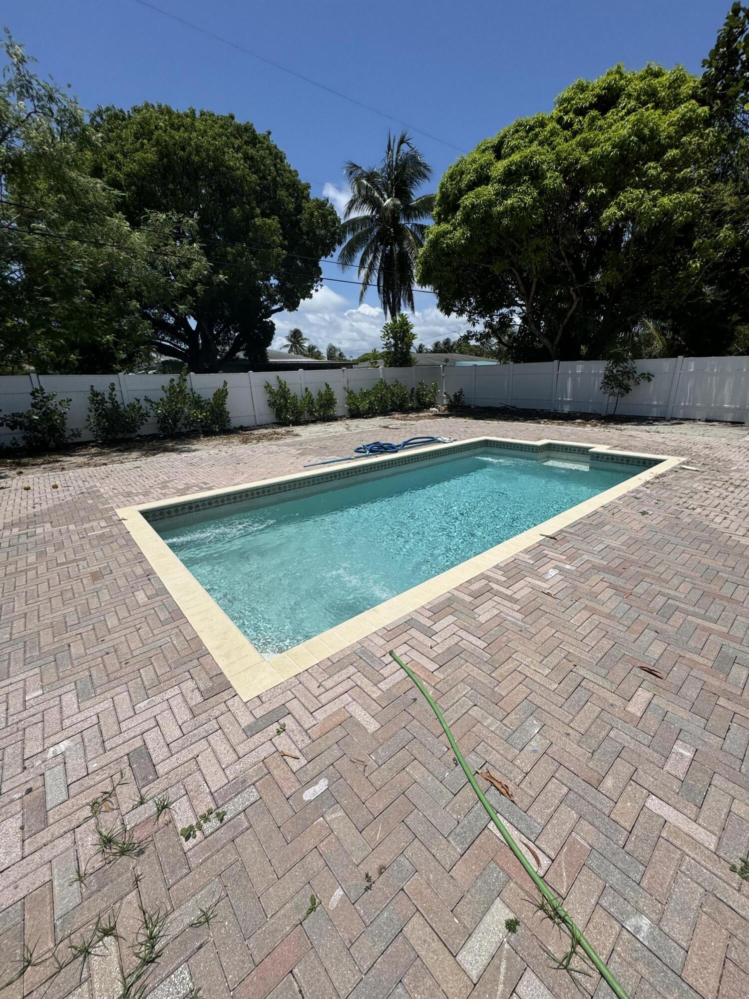 Rent INCLUDES ELECTRICITY, INTERNET, WATER, SEWER, TRASH, POOL SERVICE!!!! Just move in and bring your bathing suit! Enjoy garden & pool views through French doors. The huge backyard is completely fenced with a pristine pool. This beautiful fully REMODELED 3 bedroom home has 3 FULL baths. A double garage includes private laundry. Located just 3 blocks to the intracoastal. Beaches, tennis, and public parks are at your doorstep. Ample parking for your boats or RV. Great school zone.