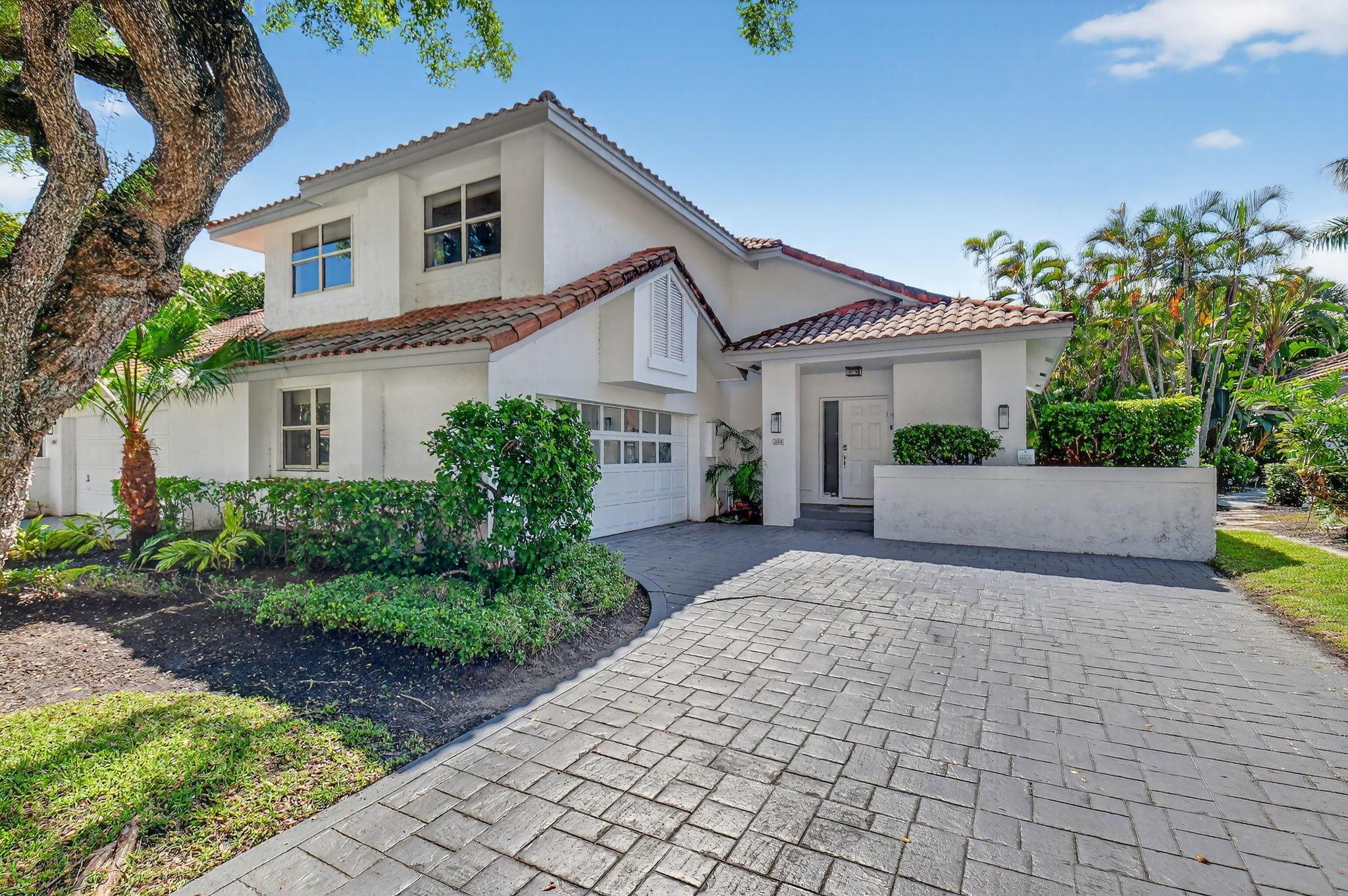 Discover this beautifully updated 2-story townhouse located in the sought-after village of Cedar Cay in the prestigious Broken Sound Country Club. This 3-bedroom, 2.5-bath home combines modern design with comfortable living. Step inside to find smooth walls, porcelain tile floors on the main level, and soaring vaulted ceilings that create a bright, open atmosphere. The sleek kitchen is designed for both style and function, featuring quartz countertops with a waterfall edge, stainless steel appliances, and ample cabinet space. Upstairs, the spacious primary suite offers a walk-in closet and a luxurious en suite bath with a freestanding soaking tub and frameless glass shower. Two additional bedrooms and a full bath complete the second floor, providing plenty of room for family or guests.