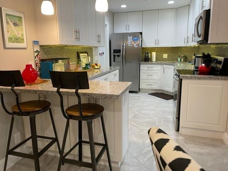 Beautiful, fully upgraded,modern & bright move-in ready corner unit. Open kitchen with SS appliances,tile floors throughout,impact windows & patio door,flat (no popcorn) ceilings,2 large bedrooms,walk in California closet in master,cable & internet $86.90/mth,convenient upfront parking with ample guest spots and all just blocks from cafes,restaurants & nightlife of Wilton Dr. Clean laundry room close by on same floor (W/D can be installed if desired). Pool,tennis/pickleball,saunas,bbq grills,clubhouse on site.
