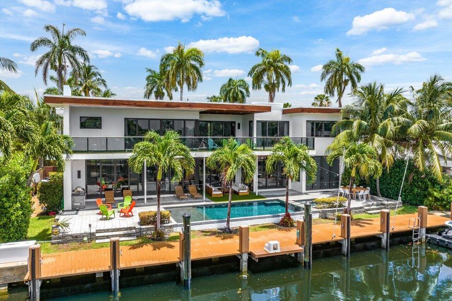 Luxurious 2016 custom estate home with 5 bedrooms plus loft & office, 6.5 bathrooms, a 3 car garage, saltwater pool, and 5250 living square feet on a 10,000 square foot lot w/ 100 feet of waterfrontage w/ private dock in fabulous Coral Ridge.  This beautiful home will wow even the fussiest of buyers with everything from its great curb appeal to its modern yet functional floor plan. Features include a double height glass entrance, volume ceilings, gourmet kitchen w/ Italian cabinetry, Sub-Zero refrigerator and Wolf range. a sparking saltwater pool & spa,
gas heater, summer kitchen, upper floor balcony w/ turf for easy maintenance, Grotto & Toto plumbing, 3 a/c units with UV systems, custom closet organizers, a wine cellar, a maids' quarters w/ bathroom, gym, 3 car garage, and so much more.