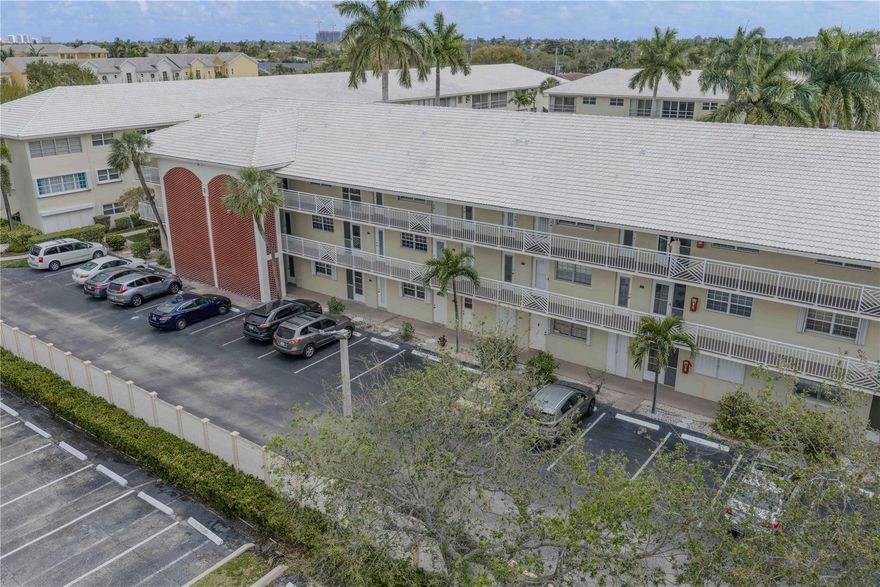 Located in desirable Lighthouse Point, this beautiful top-floor, corner unit offers exceptional location and convenience, assigned parking, great community amenities. Freshly painted, newer flooring, hurricane-impact windows, for added peace of mind and security. Both bedrooms offer walk-in closets, plus a spacious pantry for additional storage. Enjoy low maintenance living with cable included, and easy access to laundry facilities, mailboxes, and extra storage. Community amenities include a clubhouse, heated pool, bocce ball, shuffleboard, patio, bbq.  Enjoy nearby shopping, dining, the post office, library, transportation, the LHP courtesy bus, minutes to the beaches. Perfect as a full-time residence or a seasonal retreat. 55+ Community. No leasing,  No pets allowed.