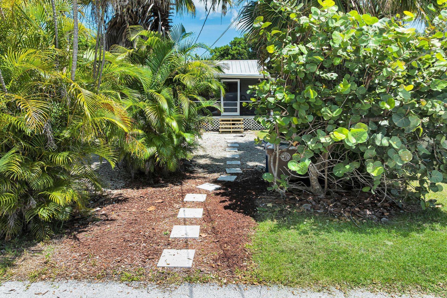 Charming home on an oversized double lot (12,500 sqft) in Big Pine Key. This 3-bedroom 2 bath home, with an office, features vaulted ceiling, brand new mini split air condition units and plenty of windows and French doors that allow light to fill the home. The large primary bedroom has a screened in porch off the back perfect for relaxing. Also, in the rear of the home is an attached, private 1/1 guest suite. The front office space is currently used as a child's bedroom. A large screened in side porch serves as extra entertaining space. A detached storage shed in the back yard as well. The double lot provides privacy and the potential for more storage and a pool.
Dade county pine floors. Close proximity to boat ramp, Grocery store, restaurants and other businesses.