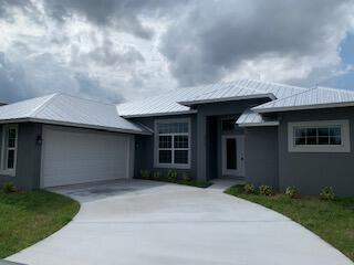 Need all level living? This is it! a 5-year-old CBS construction home with a metal roof and sprayed R-30 insulation, 3 bedrooms and 2 full bathrooms. Open floor plan with large eating bar in the kitchen, 42'' wood cabinets with granite countertops and stainless-steel appliances.All impact glass windows. 6'' x 24'' porcelain tile throughout the home. River rock installed in the showers. Located close to I-95