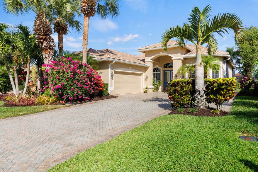 Today is a lucky day for the right Buyers!   The Seller has authorized a $25K price reduction,AND the NEW TILE ROOF IS COMPLETE!   Let's craft a win-win deal and make this piece of Florida paradise YOURS!  Are you seeking a home with a water view...in a gated community...with access to optional golf and social memberships?  Need a space where you can have room to entertain large groups?   I've got the perfect match for you.  This is a one-owner home presented with undeniable pride of ownership and a warmth that grabs you as soon as you walk in.  The claim to fame is that this was the first home built behind the South Gate of PGA Village back in 2000.  Ready for the next set of owners to create new memories. As soon as you enter the spacious foyer, you will notice the bright and open floorplan with an immediate view of the lake through the sliders. To the right is the formal dining room, where if you peek out the window, you'll see an AMAZING orchid plant hanging from the tree.  When it blooms, it's stunning!  To the left is the first guest room, which has a Murphy bed in the place of where a closet was intended.  (Murphy bed will convey with sale.)  There is a half-bathroom across the hall.  Consider this a dual master, as the second guest room has its own bathroom with tiled shower and updated vanity.
    
In the owner's suite, you'll find tray ceilings, dual walk-in closets, and a showstopper bathroom equipped with dual sinks, vanity counter, tub, separate shower, and private toilet room (what fancy people call a water closet).  Wake up in the morning to the glowing sun over the lake through your bedroom windows. 
 
The kitchen has beautiful wood cabinets, granite countertops, stainless steel appliances, and undercabinet lighting.  When designing the kitchen, the owners were smart to install a hidden power strip under the cabinets, so that they didn't have to have outlets cut into the backsplash.  The oversized breakfast nook is a direct extension to the kitchen and has housed many gatherings with a super long table and over 20 guests.  
The massive lanai features a covered and screened area to stay out of the weather and a space big enough for a dance party!  You'll also find a hot tub installed in the deck, for those nights where you just want to have a soak!  
Out front, the paver driveway leads to the side-entry 2-car garage, which also includes an additional golf cart garage space.  Need a workshop or office in addition to the home's interior space?  The Sellers have supplied heat and A/C to the garage and partitioned/screened off an area to create an office and painting studio.  This is a great way to extend the usable space of the home while still having ample room to park a vehicle.      
Big ticket updates include the A/C and water heater (2022) and roof (2025).  
PGA Village is a very active community that has something for everyone to do.  It's like living in a resort.  Stay fit by taking a swim in the resort style pool, playing a game of pickleball or tennis, shooting some hoops at the basketball courts, or bring the kids to the playground.  If you want to stay inside, check out the clubhouse where you can work out in the fitness center, shoot a game of pool, relax in the library, or join a friendly card game.   Golf and social memberships are available, but not required.  

The photos speak for themselves, but you've got to make an appointment and see this place in person to truly appreciate it!  Call and book your private showing today!