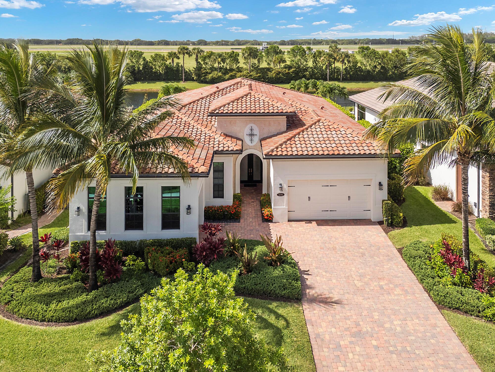 *JUST LISTED!*Experience timeless elegance and contemporary sophistication in this exquisite single-story estate home located in the exclusive, guard-gated enclave of Palm Meadows Estates. Meticulously crafted by CalAtlantic in 2017, this Cheshire model blends architectural grandeur with sleek modern finishes, offering the pinnacle of South Florida luxury living.Boasting over 3,080 square feet of beautifully designed interiors, this 4-bedroom, 3.5-bathroom residence showcases dramatic volume ceilings, walls of glass, and a seamless open-concept floor plan that radiates light and space. From the moment you enter, you're greeted with soaring tray ceilings, designer tile floors, and sophisticated finishes that create a feeling of grandeur & refinement throughout.