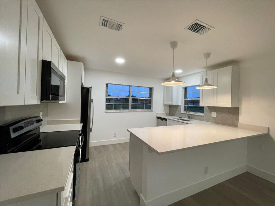 GORGEOUS 2/2 Villa in Country Manors! This Active 55+ community (with LOW HOA) is in beautiful Delray Beach (4 mi from the beach)! Villa features IMPACT WINDOWS & ACCORDION SHUTTERS,  Kitchen has Stainless Appliances, Beautiful QUARZ Counters, and New Soft-Close Cabinets! Beautifully  Bathrooms. Neutral VINYL Flooring and Paint throughout! It's like living in a private single family home - connected only by carport. Carport has large utility room for extra storage. Country Manors is a well-established community - minutes from Downtown Delray and the Beach!