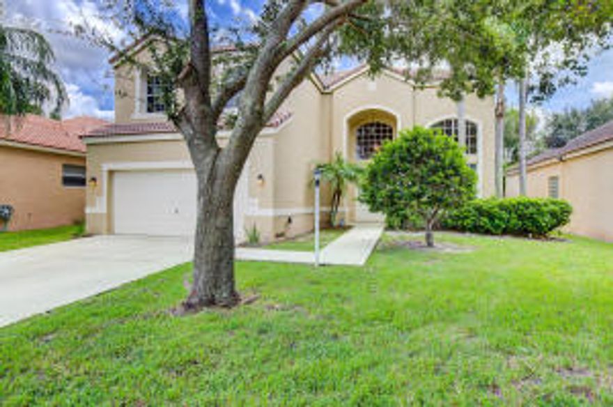 This gorgeous, meticulously maintained home in a gated community in Parkland Florida is ready for you to move into! Walk into your home and be greeted with an open floor plan featuring soaring ceilings in the dining area and family room with oversized windows for natural light. An extra large, screened in, wrap around porch offers you the chance to relax and take in the intimate view of the backyard which is large enough for a future pool. The entire first floor is tile with beautiful laminate wood stairs leading up to your 2nd floor. Luxurious marble countertops in the bathrooms with decorator lighting. Enjoy all that the area has to offer, including a large park right across the street, swimming pool, playground area, clubhouse and fitness center. New water heater (2013) and A/C (2012)