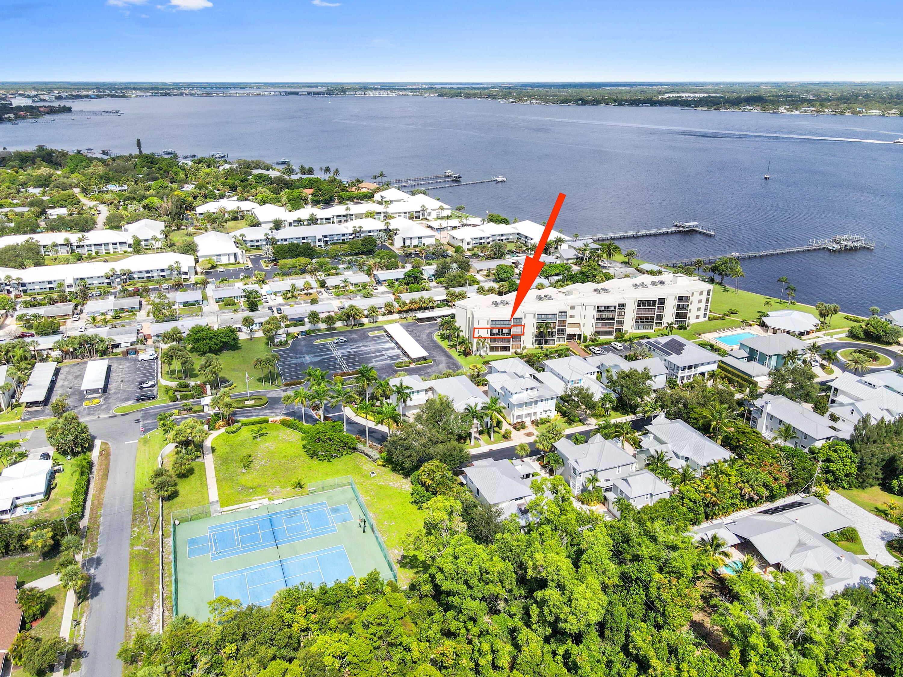 Prepare to be captivated by this absolutely gorgeous river-side condo, a hidden gem offering breathtaking and amazing sunset views! Situated in the desirable Four Winds On River Condo community, this 2-bedroom, 2-bathroom residence perfectly blends serene living with modern comfort. The interior is bright and cozy, with a thoughtful mix of carpet and tile flooring that creates a warm and inviting atmosphere. The galley-style kitchen, complete with a classic tiled backsplash, is a functional and stylish space perfect for preparing meals while enjoying the scenic views.
