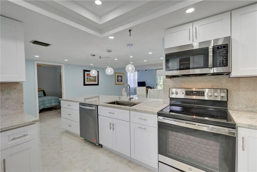 EAST, EAST, EAST! ALL AGES WELCOMED! Spectacular Unit 2/2 with the potential 3rd bedroom. Note: Wall is down, easy to put back up in Boca Teeca! This beautiful condo features a new, completely remodeled kitchen w/ quartz countertops & SS appliances. Enjoy this spacious condo's split floor plan, with tile flooring throughout, and the convenience of the in unit laundry room with a brand new washer and dryer. Enjoy the breathtaking views of the resort style pool with beautiful palm trees from the screened in balcony. The in unit AC was replaced in 2018 and the water heater was replaced in 2013.  Great location, just minutes from the beach, Mizner Park, shopping, and great dining. Great budget, elevator in building, don't miss out on this one!! Any Assessments have been paid by seller. Top "A" Rated Schools including Boca Raton Community Middle School & Boca Raton Community High SchoolThis is an amazing location in a secure building. Service animals ok. This is a real beauty to show. Come to Florida and sit on your balcony over looking the pool while sipping your morning coffee.