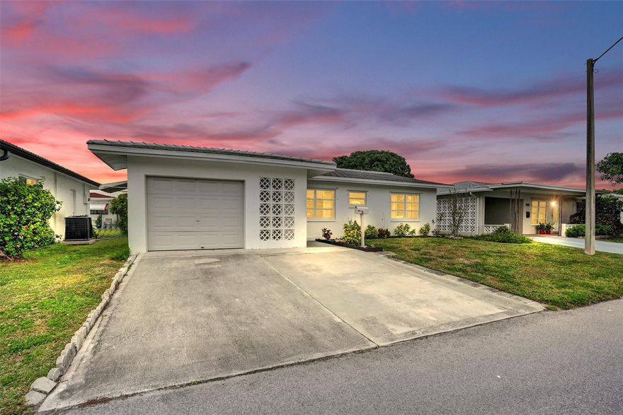 Located within a welcoming 55+ community, Imagine incredible ease of living in this adorable home with newly expanded kitchen and coffee bar feature, stainless steel appliances, white Shaker cabinets and shiny quartz countertops. Spacious primary suite and guest suite are complemented by the bonus office/den bedroom currently featuring a desk and daybed.  Meticulously maintained and luxuriously upgraded, this charming Mainlands cottage is a remarkable opportunity. Enclosed Florida room means two large living areas plus formal dining. The plethora of storage extends into the converted garage featuring workshop, storage and and laundry room. Garage can easily be converted back to full single car plus laundry. This community offers amenities including park, clubhouse, and 2 pools.