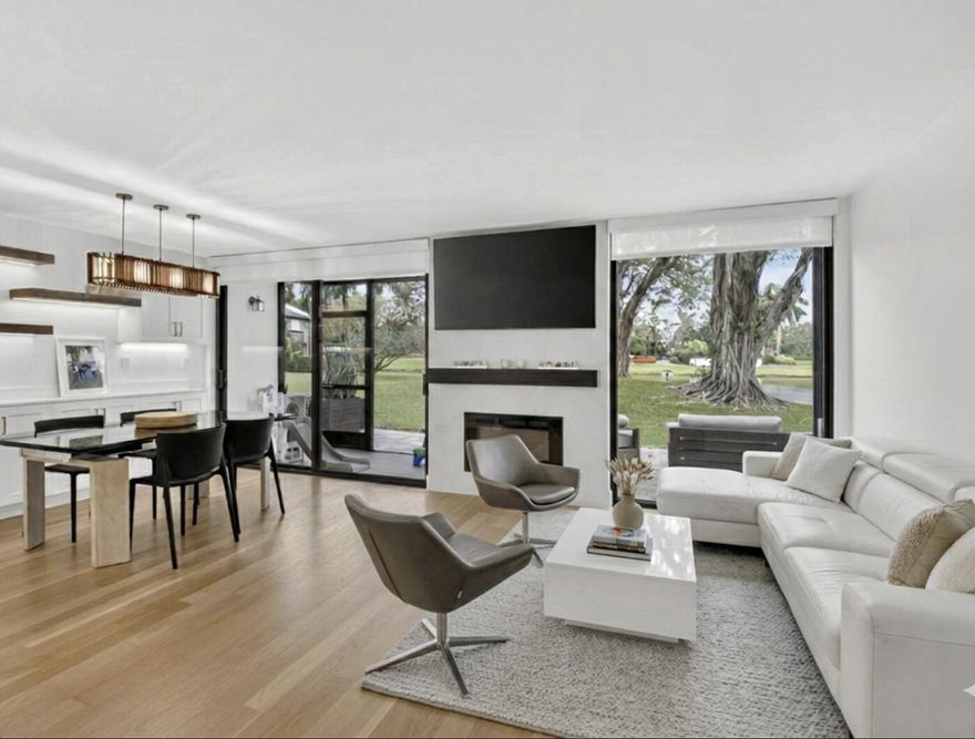 Welcome to luxury living in Pinelake at Boca West Country Club. This stunning, fully renovated home features a modern aesthetic with natural hardwood floors and soaring vaulted ceilings that floor the space with light. The heart of the home is a sleek, updated kitchen complemented by three designer bathrooms.

Designed for comfort, the primary suite is conveniently located downstairs, with two spacious guest bedrooms above. Enjoy peace of mind with hurricane impact glass throughout. Step outside to your private lakeside patio, featuring a dedicated area to BBQ and serene water views. This residence also includes golf cart parking, perfect for navigating the world-class amenities of Boca West. Experience the perfect blend of style and tranquility in this premier golf community.