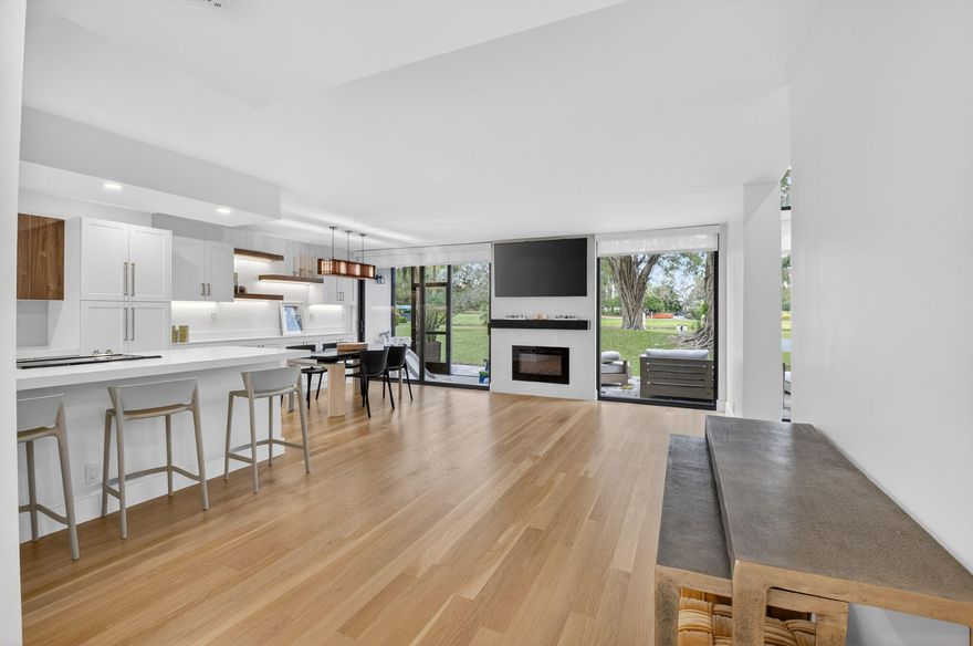 Welcome to luxury living in Pinelake at Boca West Country Club. This stunning, fully renovated home features a modern aesthetic with natural hardwood floors and soaring vaulted ceilings that floor the space with light. The heart of the home is a sleek, updated kitchen complemented by three designer bathrooms.

Designed for comfort, the primary suite is conveniently located downstairs, with two spacious guest bedrooms above. Enjoy peace of mind with hurricane impact glass throughout. Step outside to your private lakeside patio, featuring a dedicated area to BBQ and serene water views. This residence also includes golf cart parking, perfect for navigating the world-class amenities of Boca West. Experience the perfect blend of style and tranquility in this premier golf community.