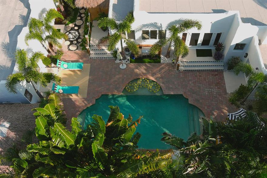 A property like this may never come again! LARGE MAIN HOUSE AND LARGE GUEST HOUSE EACH WITH FULL KITCHEN, WASHER, DRYER & SO MUCH MORE. NESTLED ON AN ULTRA PRIVATE QUIET REOSRT STYLE LOT IN COVETED DELL PARK. Take the Delray Beach Freebee Golf Cart or your own to get to Atlantic Ave and the beaches in munutes from this premiere location. The possibilities are endless with this expertly modernized one-of-a-kind resort style compound in the heart of Delray Beach. Live in the luxuriously appointed main home in total privacy while your family and friends visit in their own stylish guest house. Or lease out the guest house for short- or long-term clients as an investment property when you're not in residence. Situated on an oversized lot & located 'in town' off Historic N Swinton Ave affording