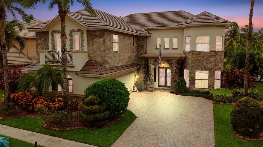 Prepare to be enchanted by this truly magnificent waterfront estate, perfectly nestled in a desirable, lake-front community in Wellington. The home immediately impresses with its grand, European-inspired architecture, featuring a new roof, new impact windows & doors, an elegant stone and stucco facade, permanent whole house generator and a sweeping paver driveway leading to the attached garage. The meticulously manicured tropical landscaping and towering palm trees frame the residence, setting a tone of upscale elegance before you even step inside.