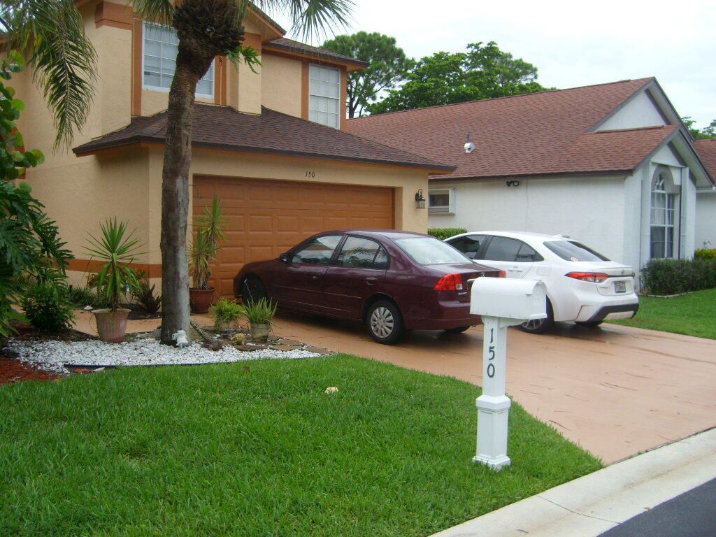 Photo of 150 Paddock Lane Ln, Green Acres, FL 33413 (MLS # R10767497)